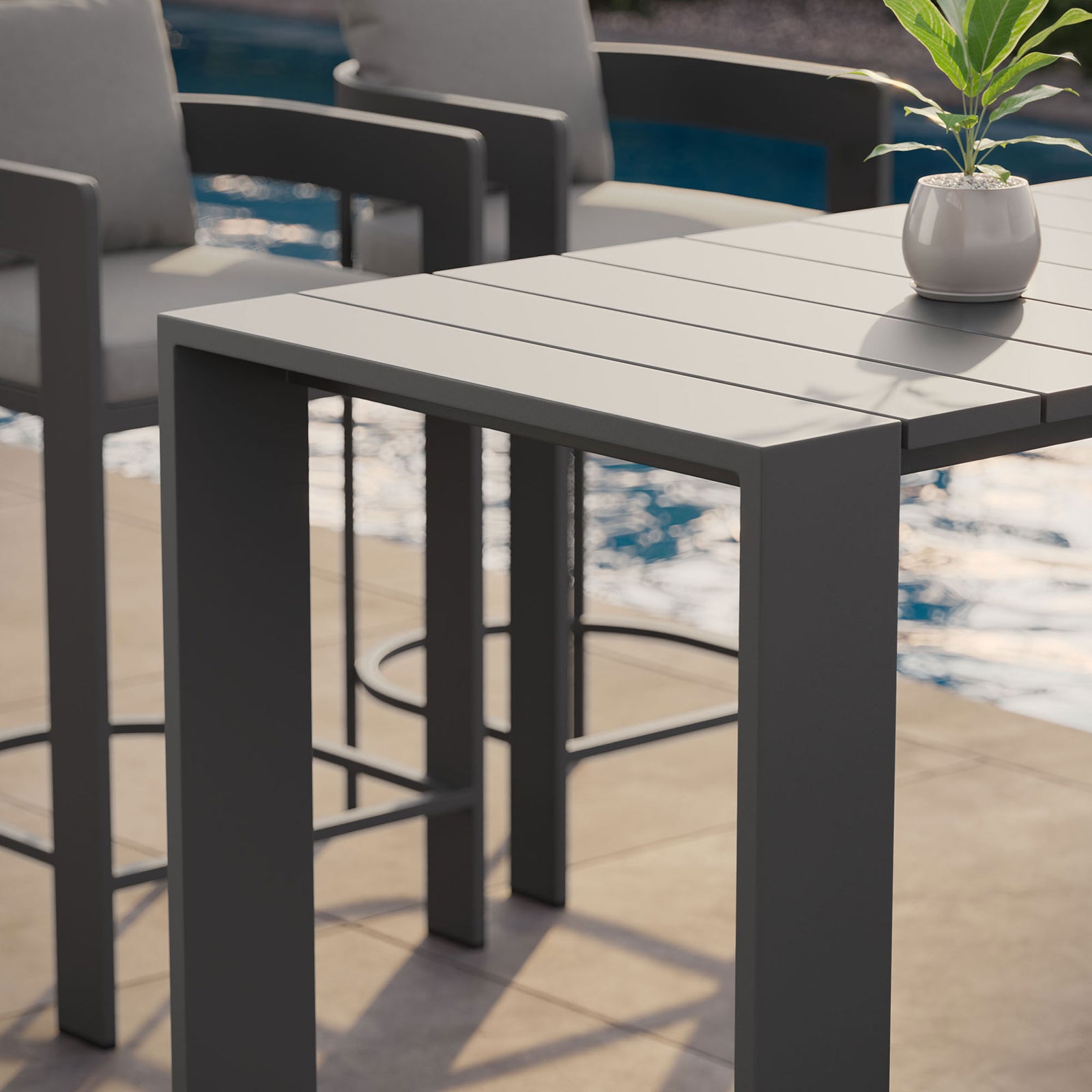Gray slatted bar table styled poolside with matching stools and a small potted plant || EEI-7593-GRY || detail_room