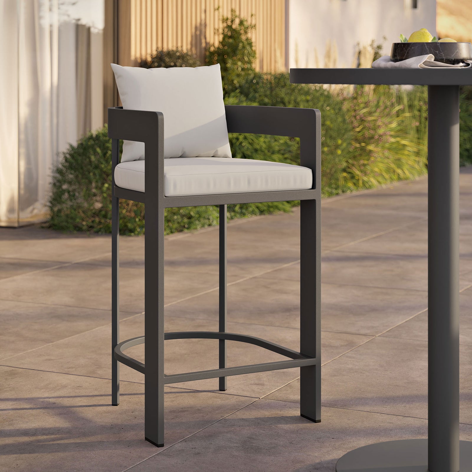 Tahoe bar chair with white cushions styled at a modern outdoor bar table for relaxed entertaining. || EEI-7595-WHI || front_angle_room