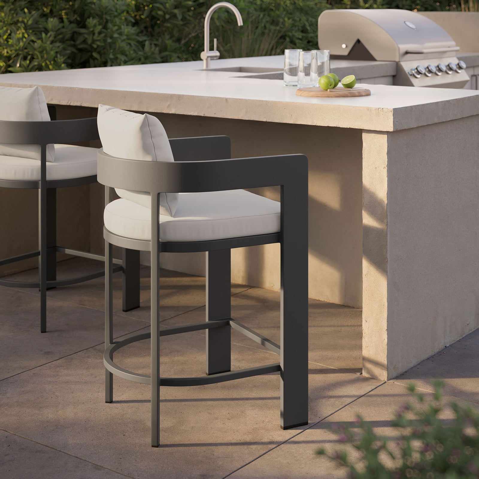 Tahoe counter stool with white cushions arranged at an outdoor bar for airy, poolside entertaining. || EEI-7596-WHI || front_angle_room