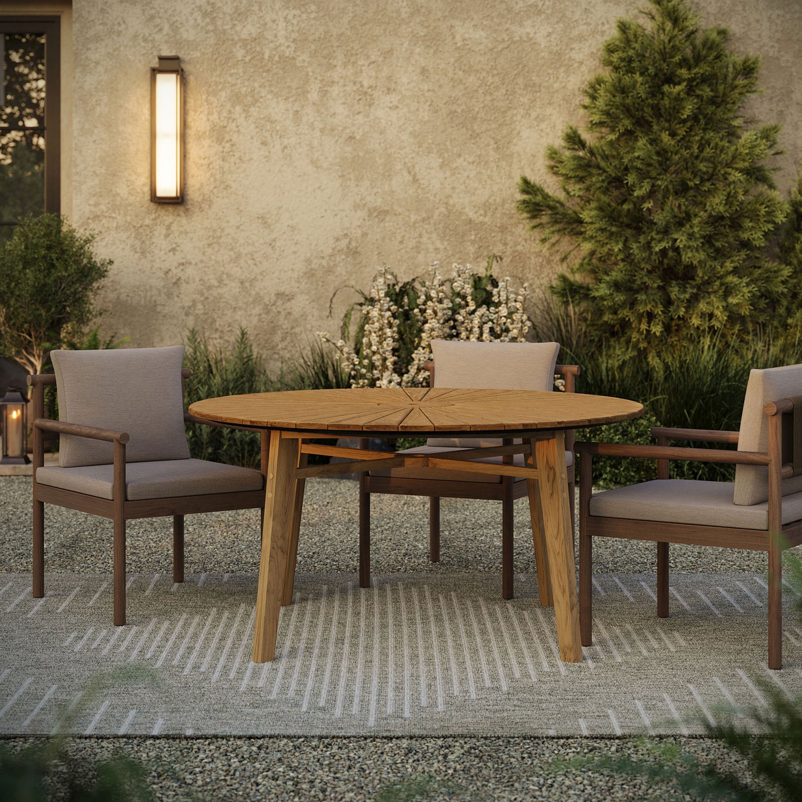 Cielo round teak patio dining table styled with lounge chairs on a textured outdoor rug || EEI-7601-NAT || front_room