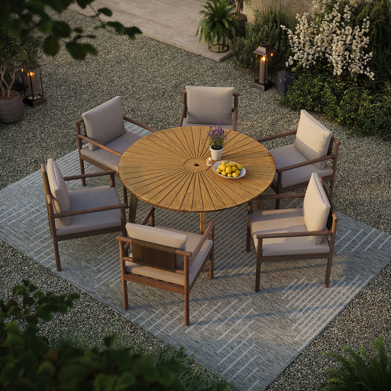 Cielo 59-inch round teak dining table set for six on a patio, showcasing generous seating space || EEI-7601-NAT || top_angle_room