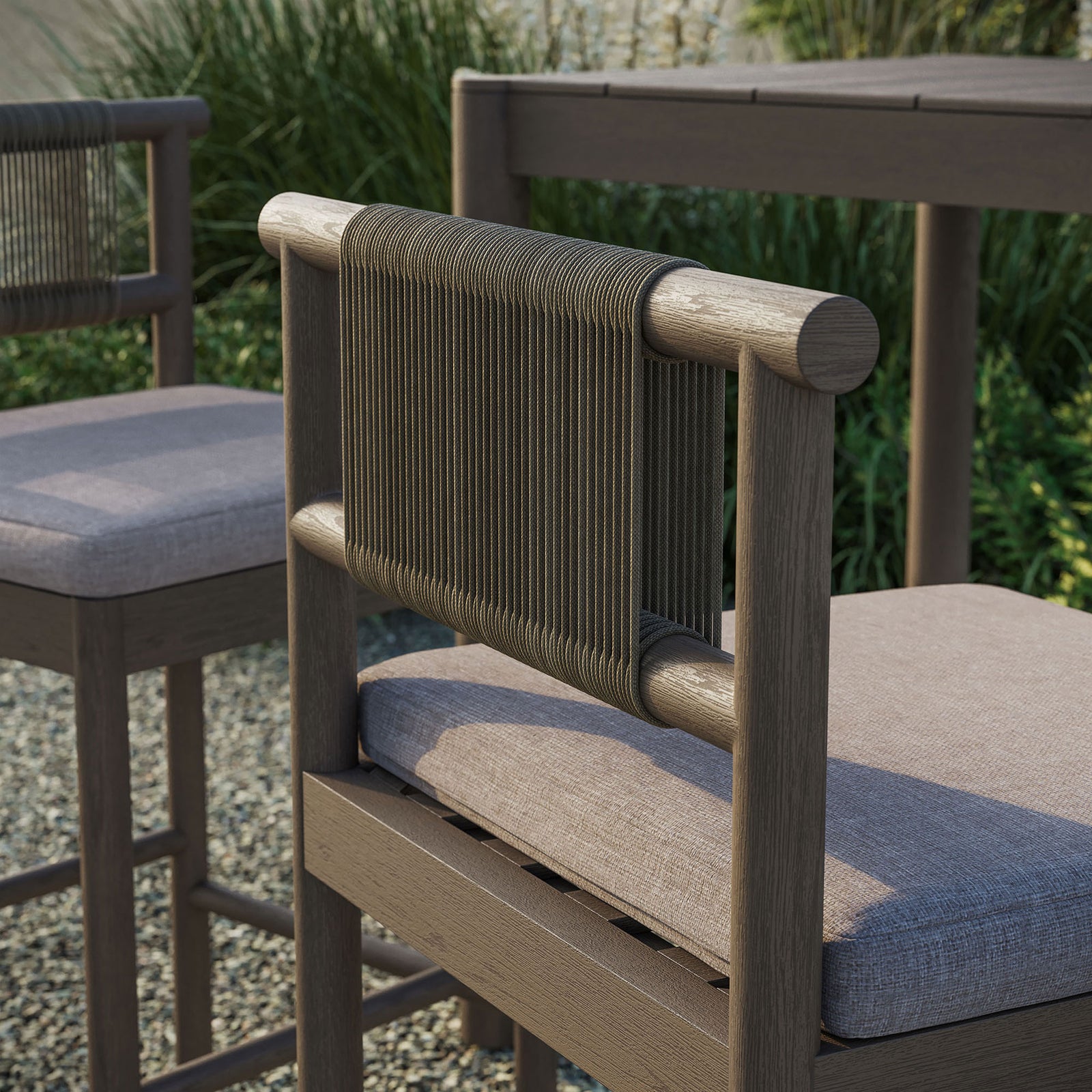 Outdoor close-up of weathered gray bar stool rope back and pebble cushion beside bar table || EEI-7626-WGR-PEB || detail_room