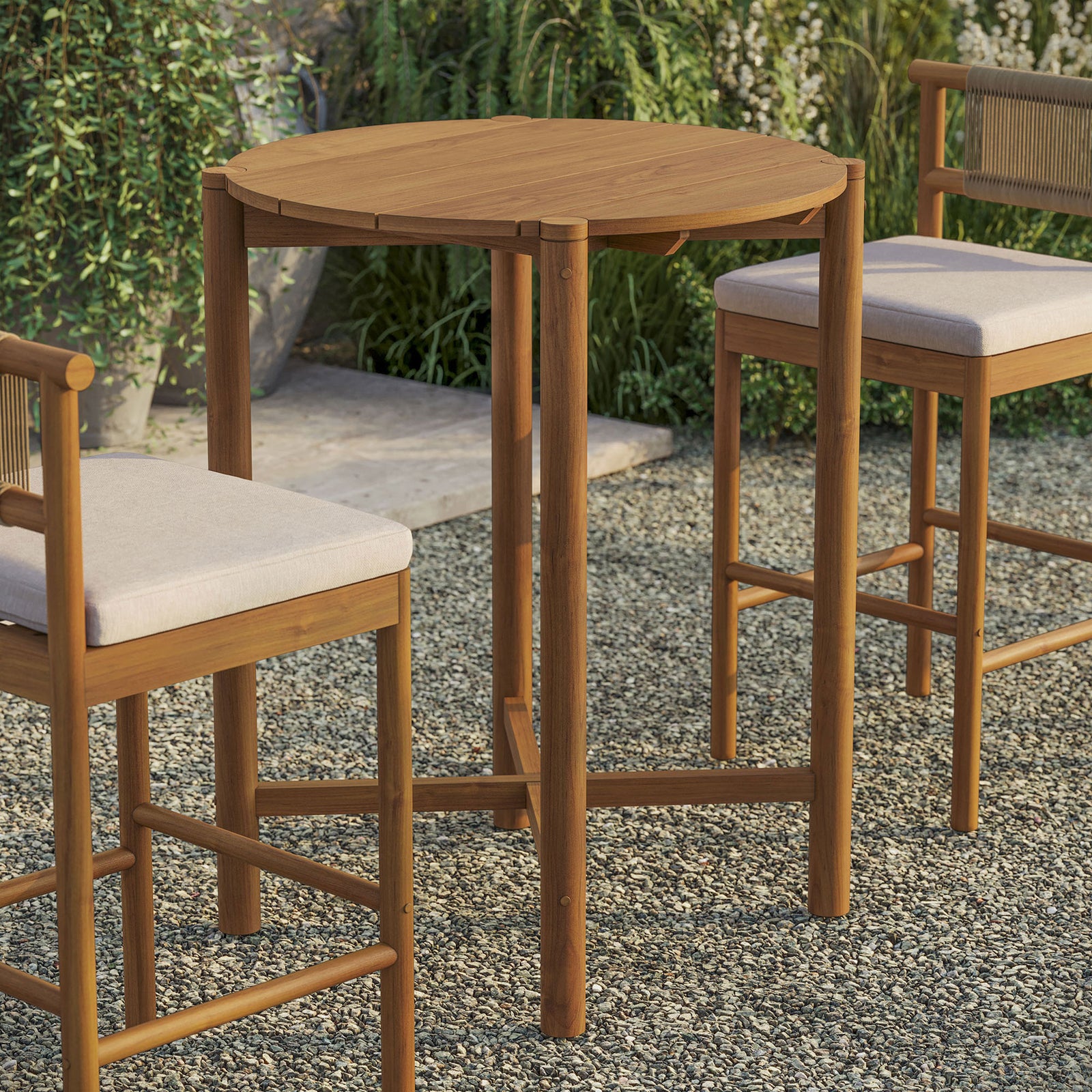 Natural teak round bar table creates a cozy outdoor perch with coordinating stools || EEI-7628-NAT || front_angle_room