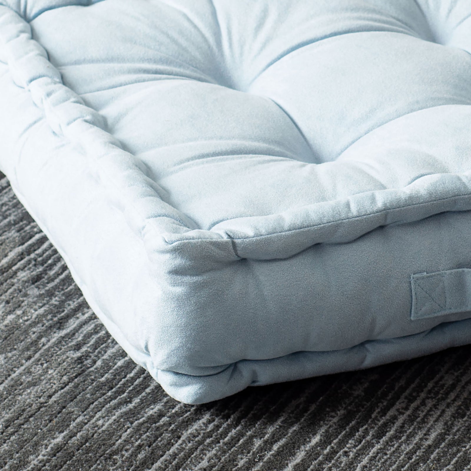 Soft blue floor pillow with deep tufting and a plush, gathered corner || FLP1002A || detail_room