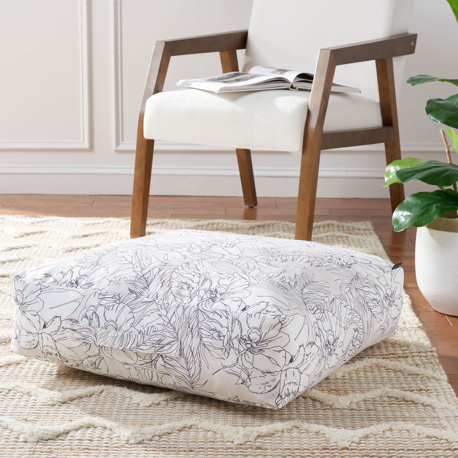 Generously padded floor pillow brings beige-and-black floral pattern to a living space. || FLP1012A || front_angle_room