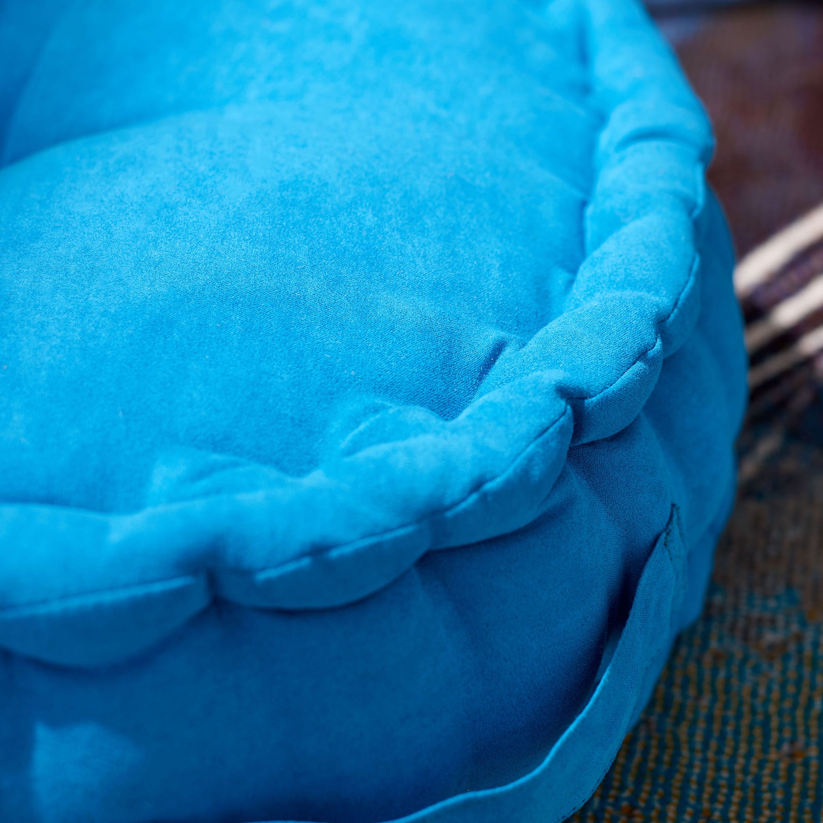 Soft blue fabric and a plump, gathered rim bring inviting texture to this floor pillow || FLP1014C || detail_room
