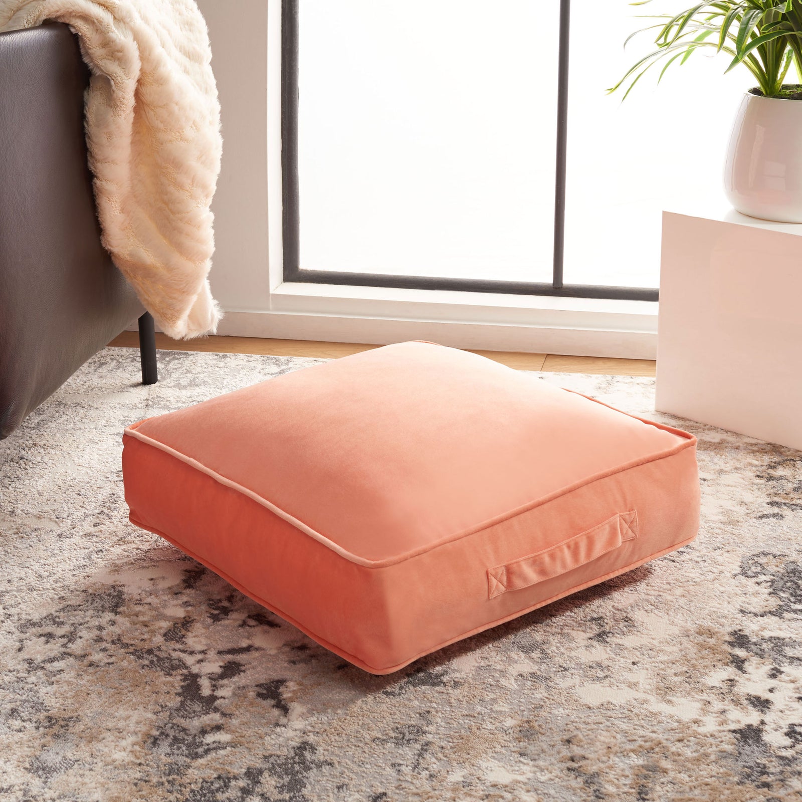 Generously cushioned peach floor pillow adds cozy seating, with piped edges and a handy side handle || FLP1015A || front_angle_room