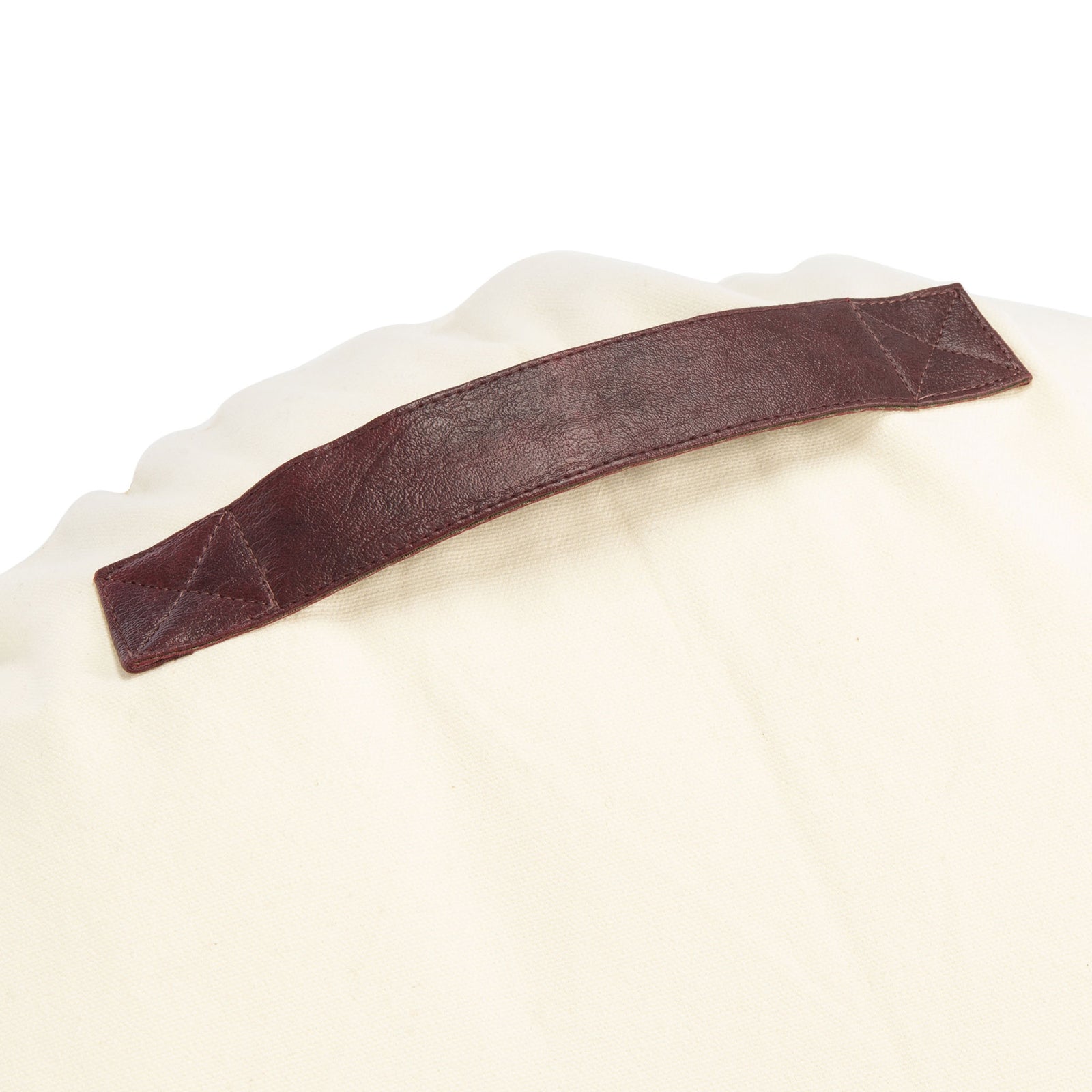 A dark brown carrying strap is stitched to the soft cream backing || FLP3001A || handle_studio