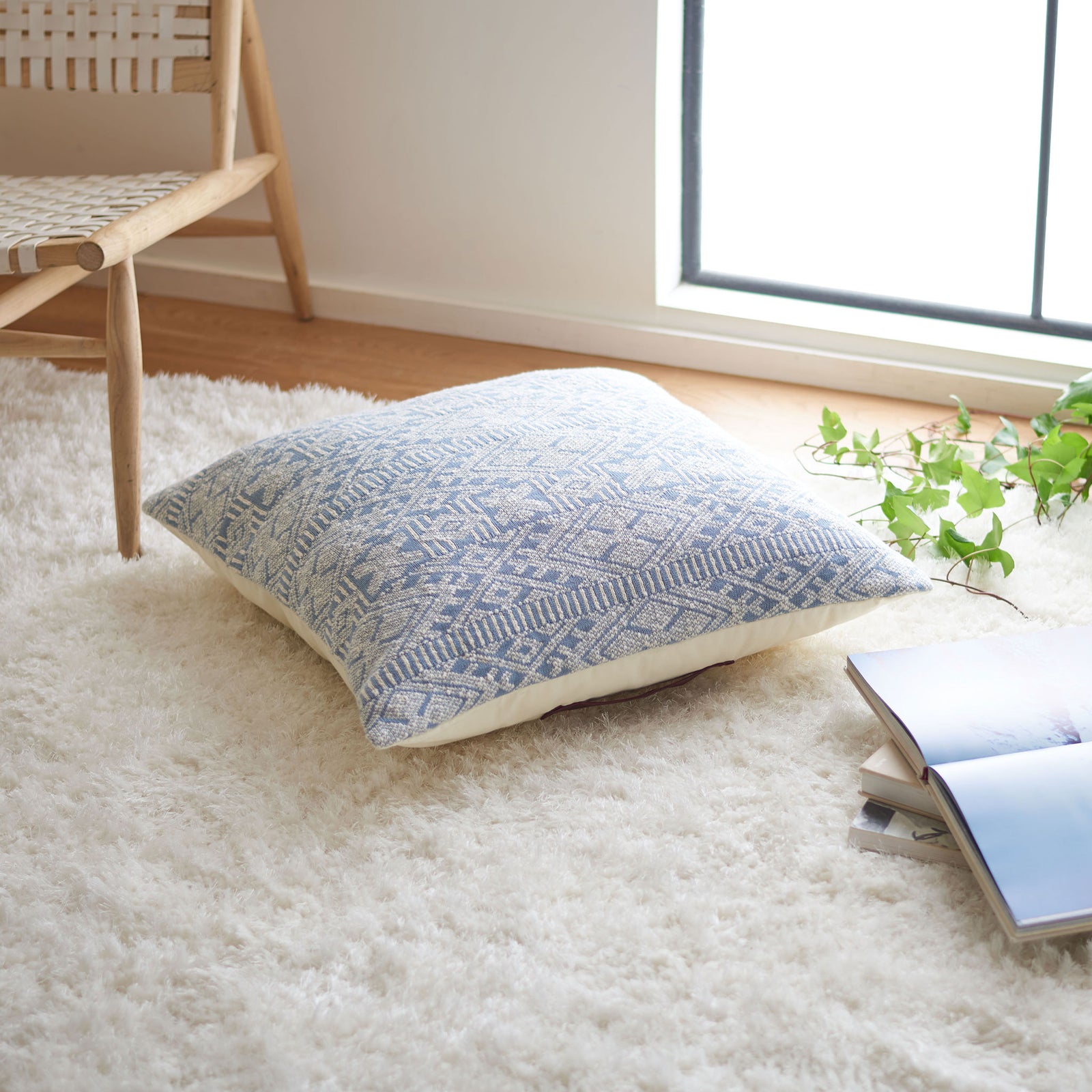 Blue and beige geometric floor pillow offers a plush place to settle beside a chair || FLP3002A || front_angle_room