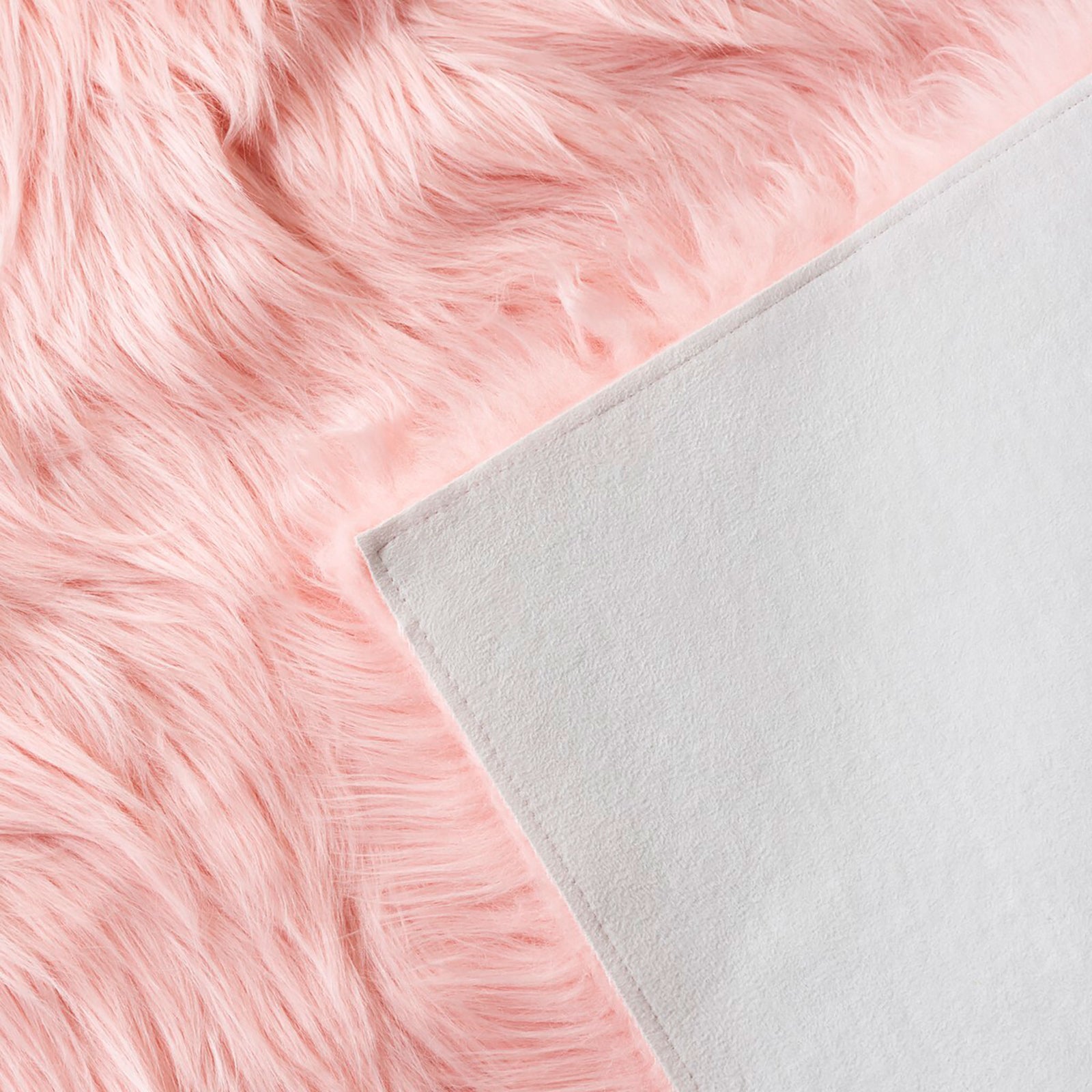 Pink faux sheepskin rug showing its long fluffy fibers and smooth white fabric backing || FSS235G-2 || backing_studio