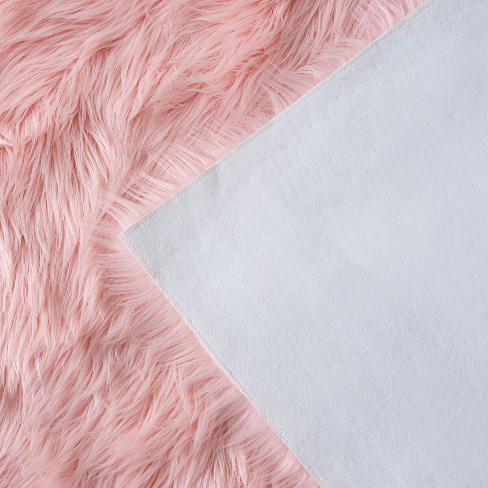 Folded pink faux sheepskin rug revealing its soft white fabric backing and long shag fibers || FSS235G-5 || backing_studio