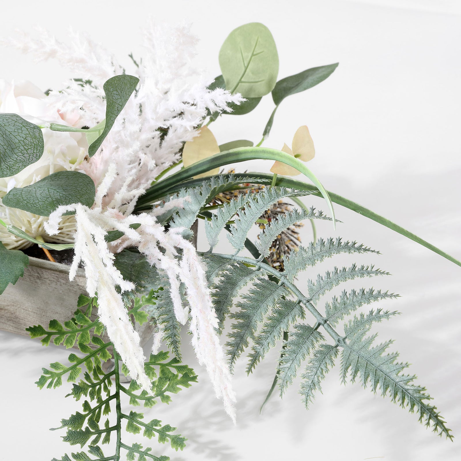 Soft white sprigs and silvery ferns spill beyond the shallow planter. || FXP1013A || detail_studio