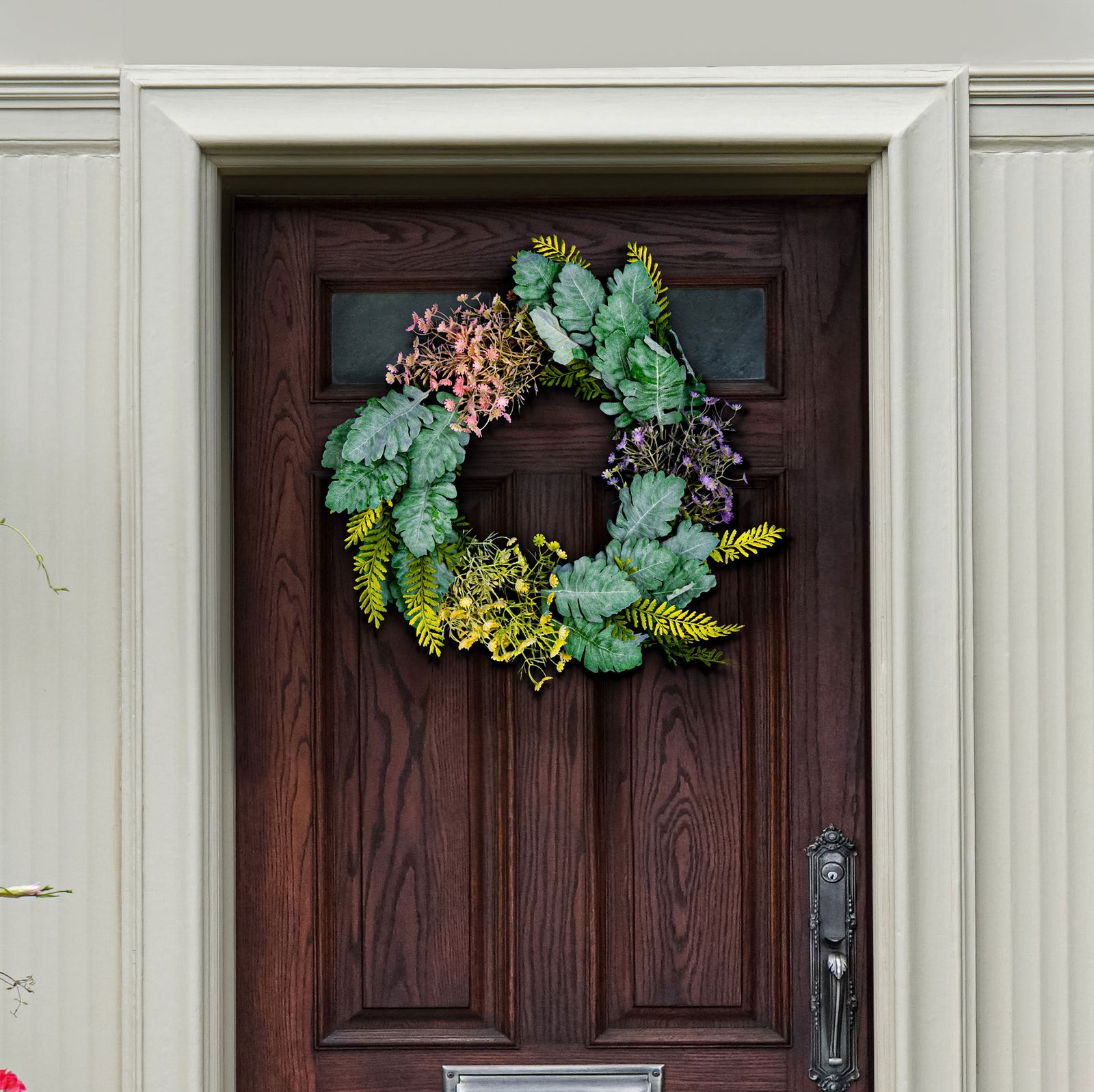 Silvery leaves and delicate spring flowers soften a dark entry door. || FXP1036A || front_room
