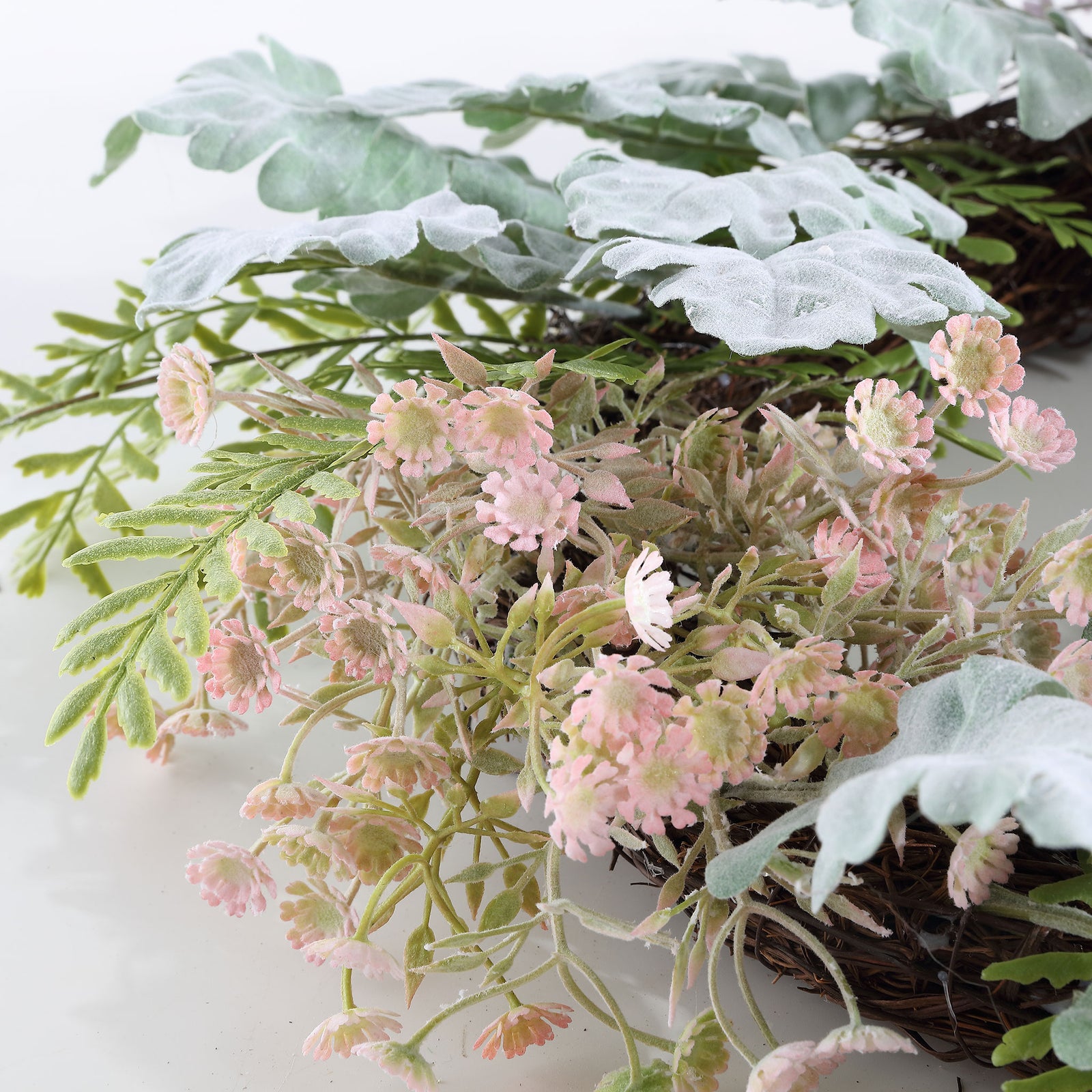 Small blush blossoms peek through frosted-looking leaves and wispy stems. || FXP1036A || detail_studio