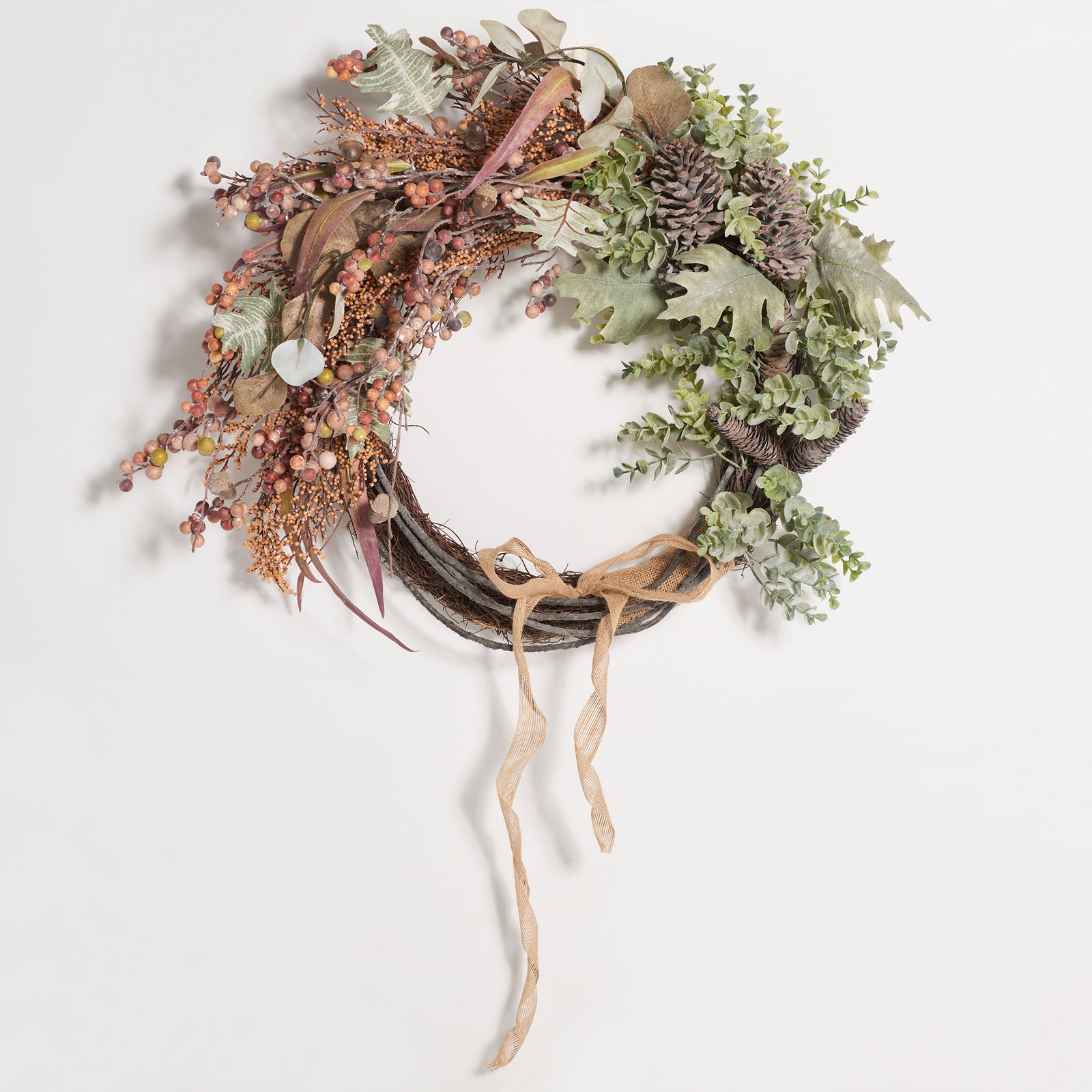 Rustic berries and eucalyptus foliage frame an airy twig ring and natural bow. || FXP1044A || front_studio