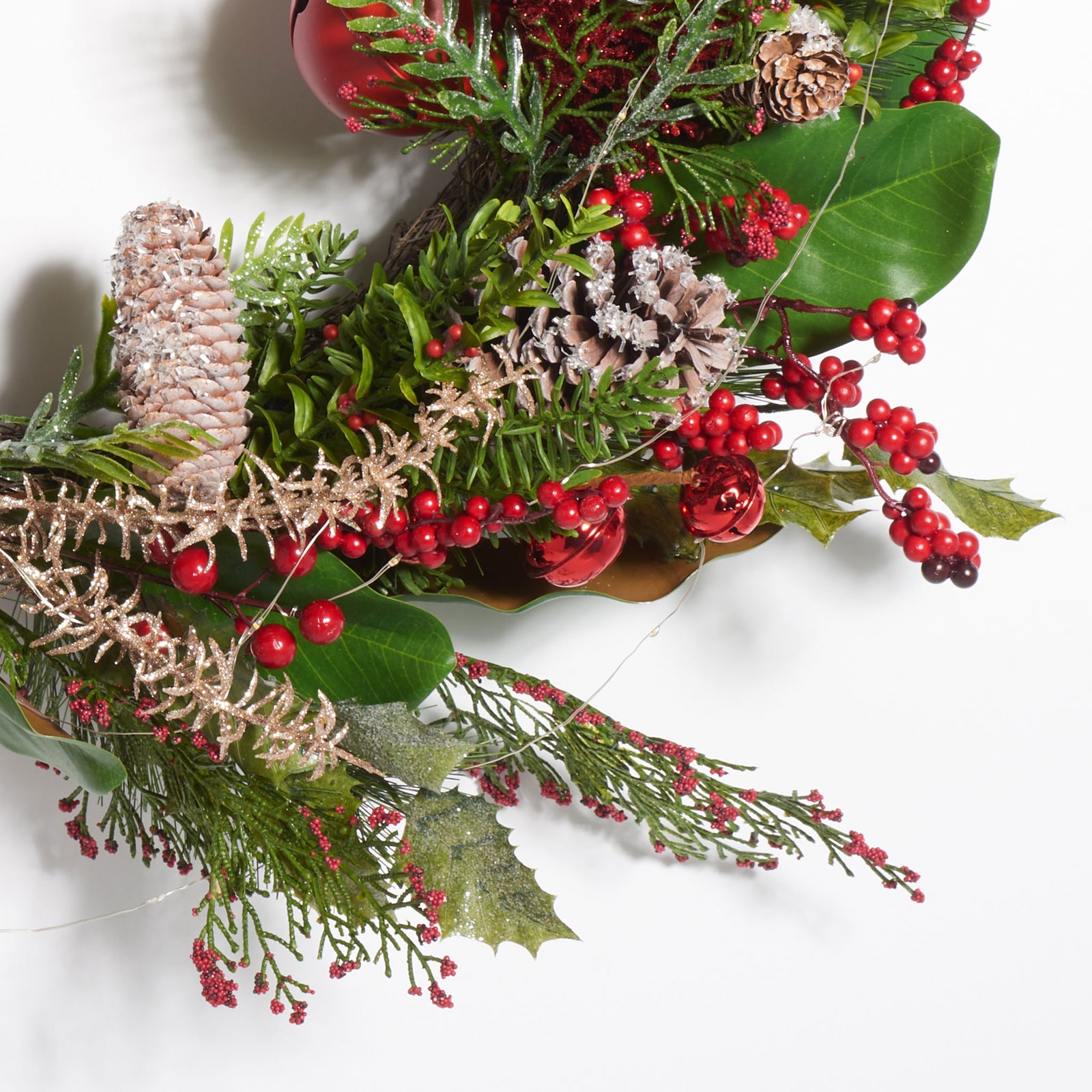 Glossy red bells and berries nestle among pine cones and green foliage. || FXP1092A || detail_studio