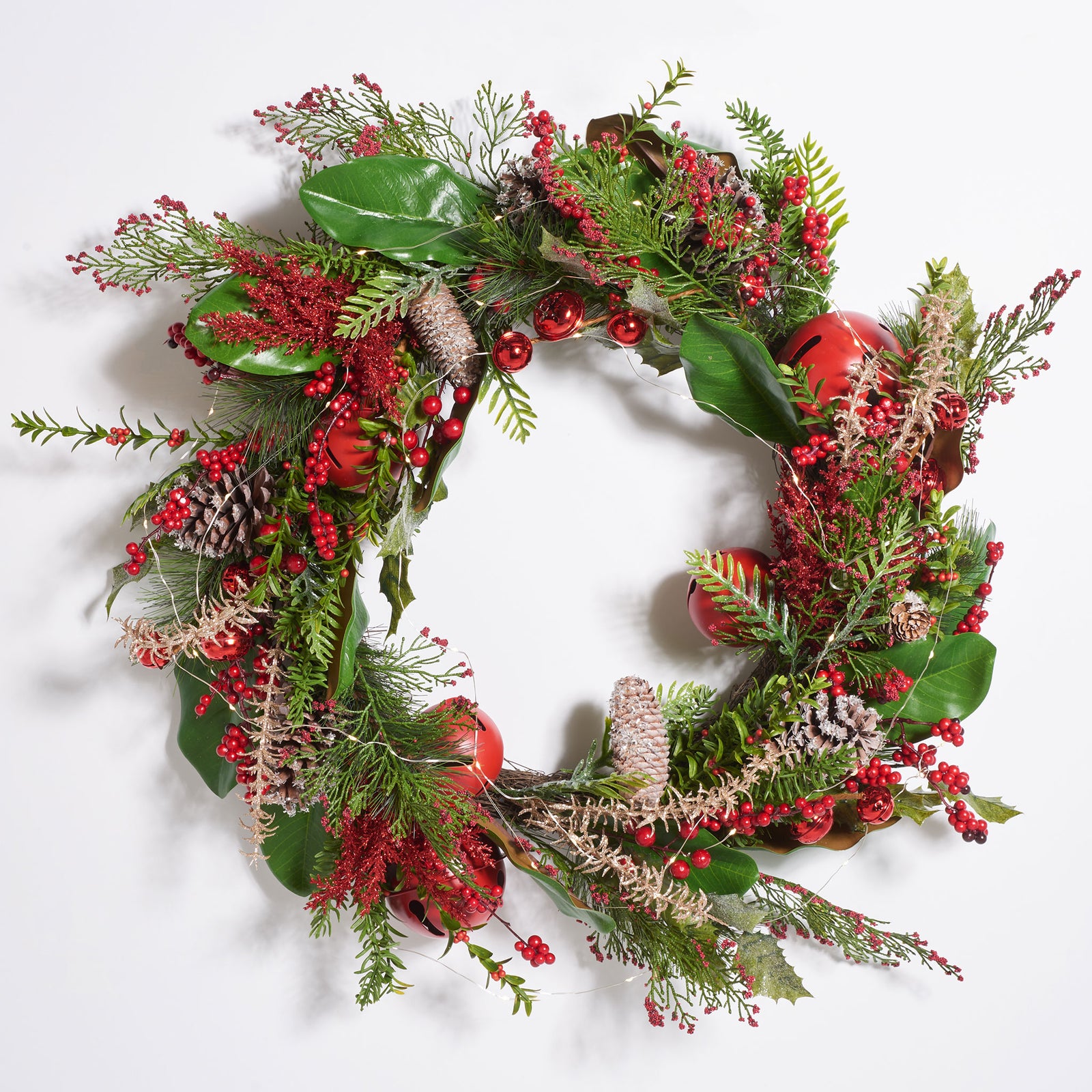 Warm LED lights glow among red ornaments and layered green sprigs. || FXP1092A || front_on_studio