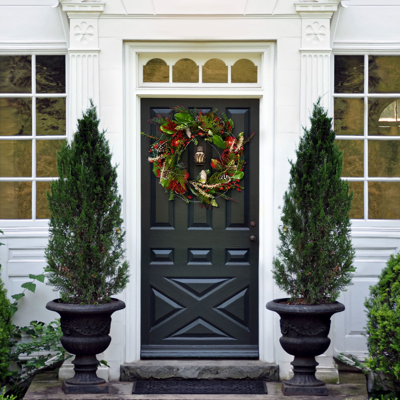 A green and red wreath adds a festive flourish to a dark entryway. || FXP1092A || front_room