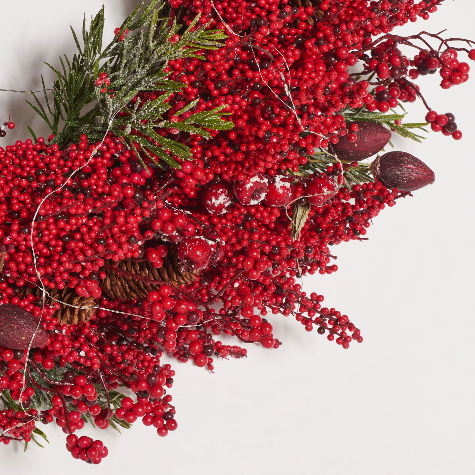 Dense red berries, pine needles, and tiny LED wires add layered texture. || FXP1093A || detail_studio