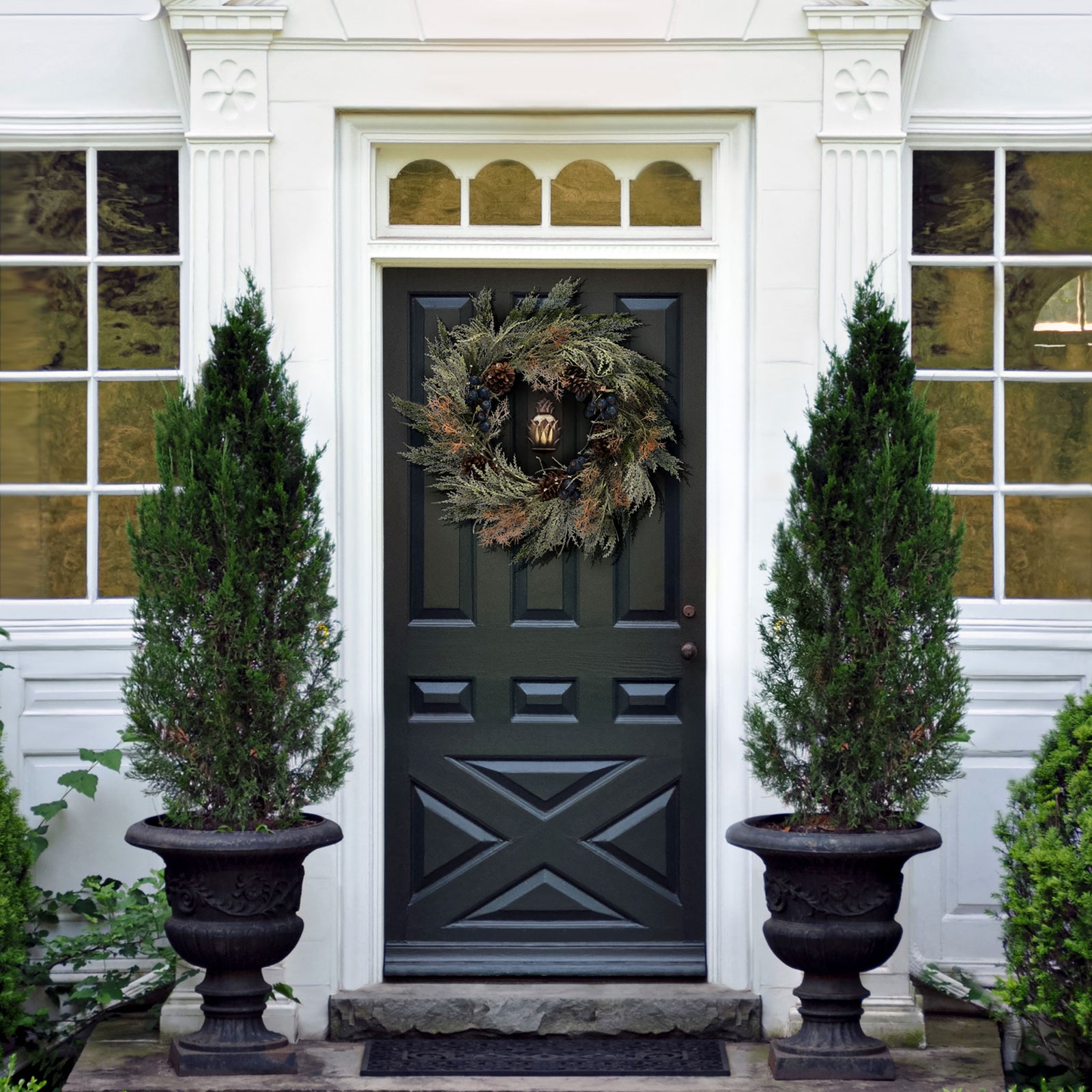 A pine and berry wreath adds cool woodland color to the entryway. || FXP1094A || front_room