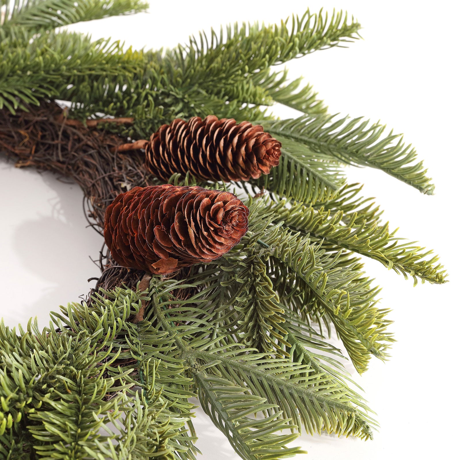 Brown pine cones emerge from soft green evergreen needles. || FXP1095A || detail_studio