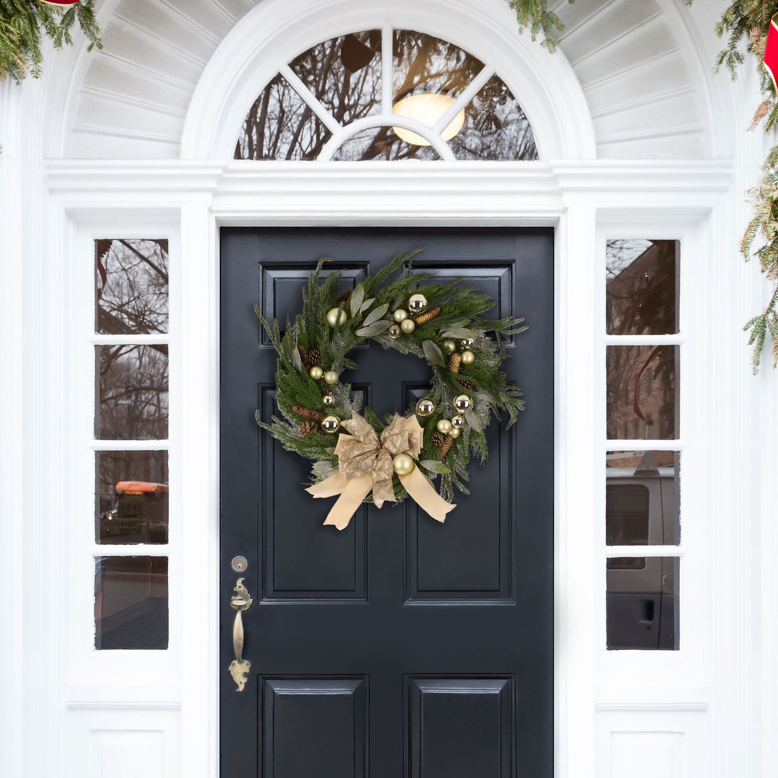 A welcoming evergreen wreath blends delicate gold ornaments with a generous cream ribbon bow. || FXP1100A || front_room