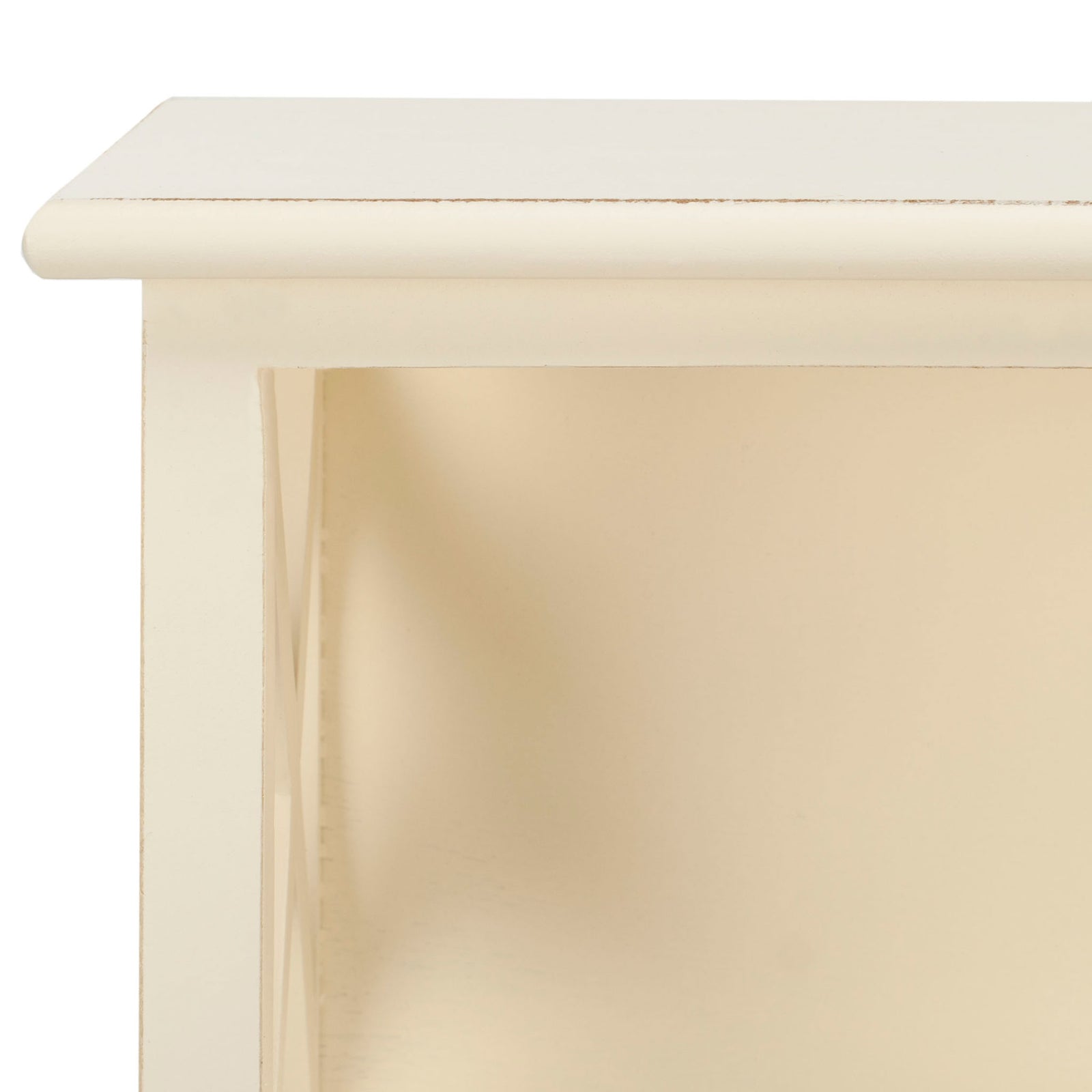 Smooth white-painted wood and a rounded upper ledge frame an open storage cubby. || HAC5703C || detail_studio