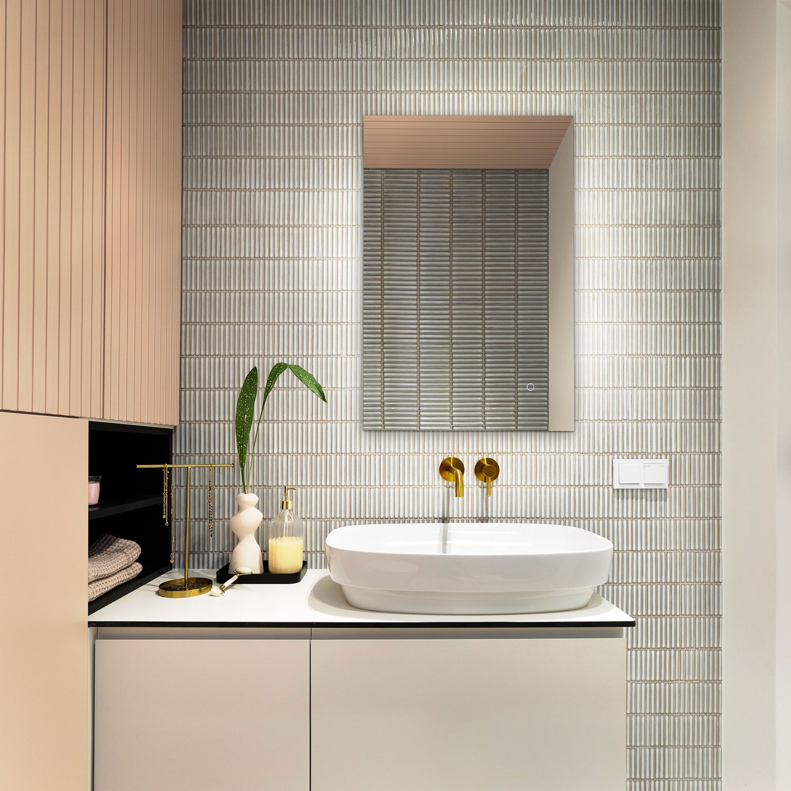Integrated LED lighting creates a soft halo around the sleek mirror above a bathroom sink. || LMR1006A || front_on_room