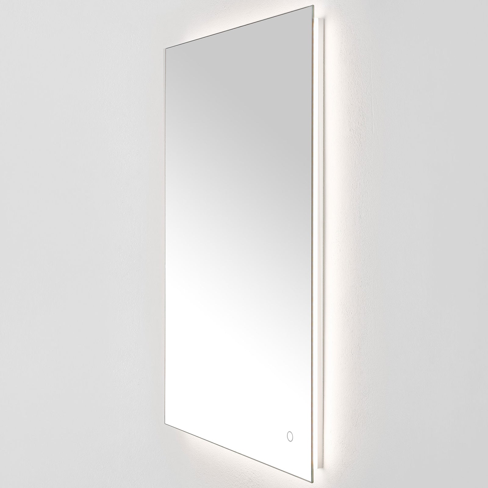 Gentle white backlighting outlines the tall mirror and its narrow aluminum-backed edge. || LMR1006A || front_angle_on_studio