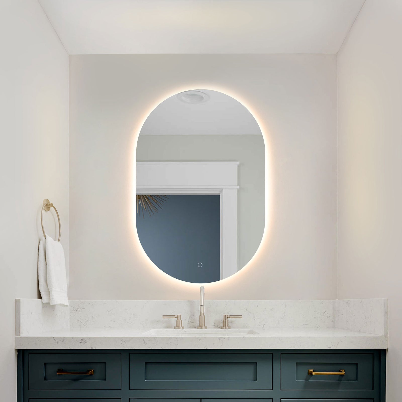 A glowing LED halo frames the rounded mirror above a blue bathroom vanity. || LMR1007A || front_on_room