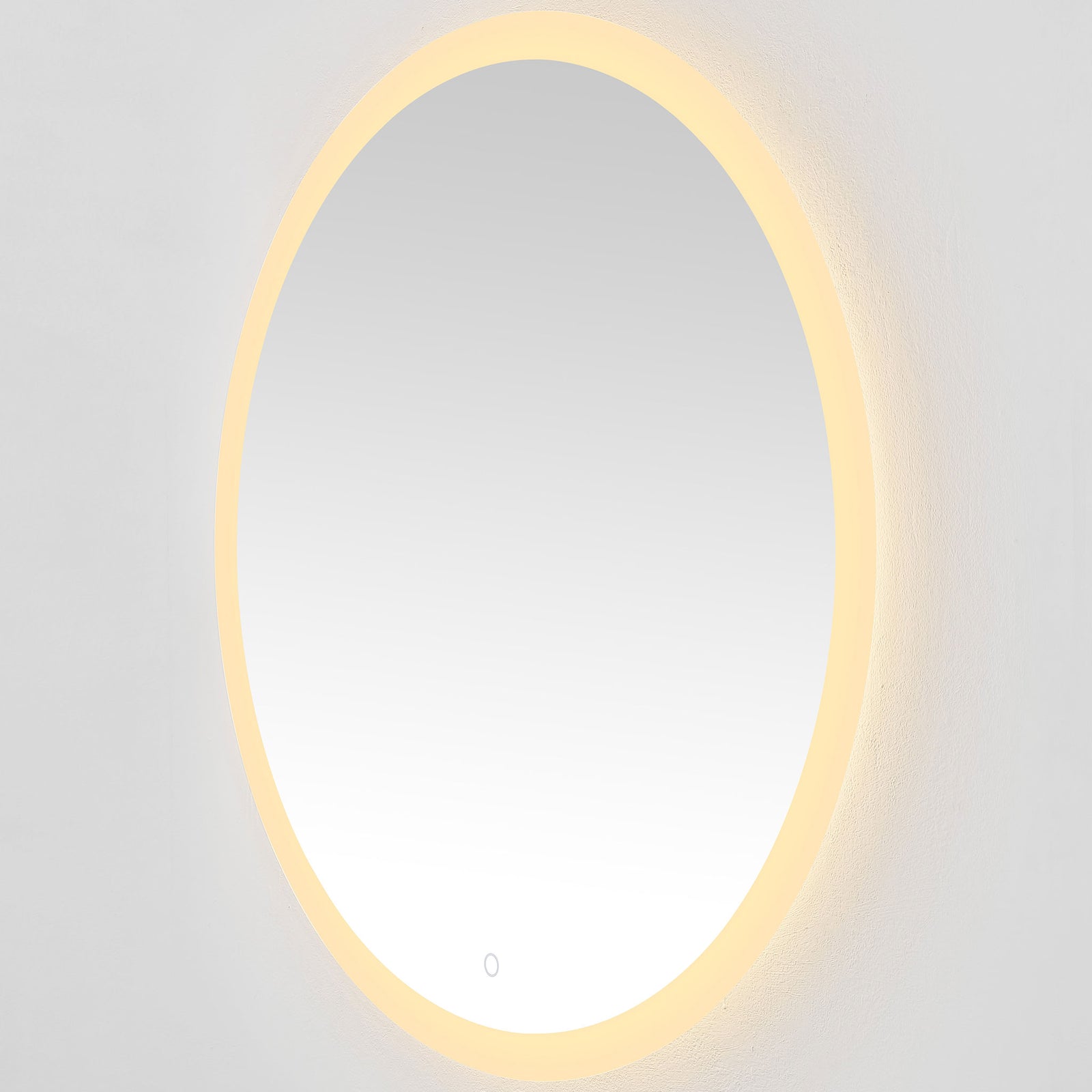 A golden LED ring brings a cozy glow to the round mirror and surrounding wall. || LMR1008A || front_angle_on_studio