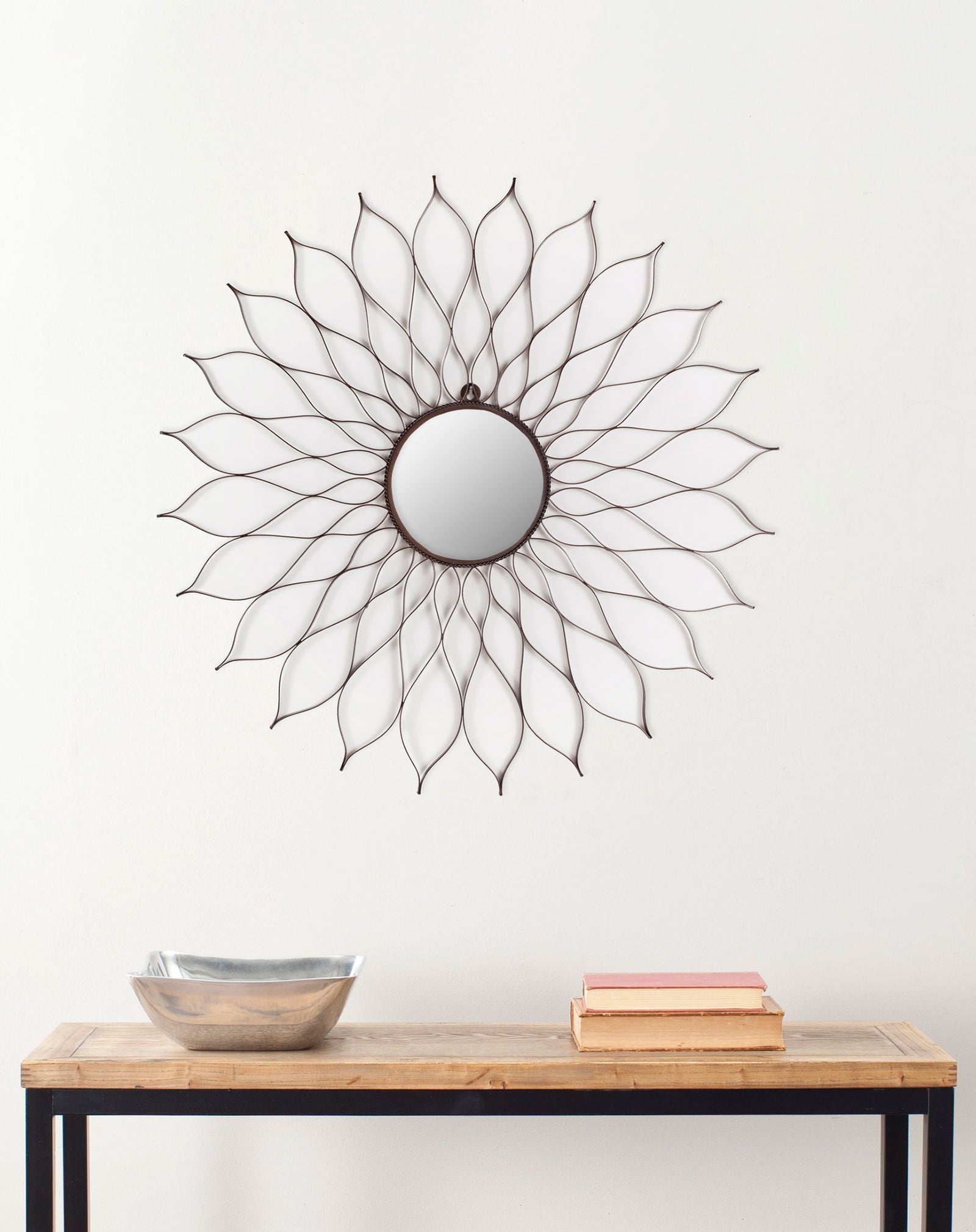 A floral mirror with delicate brown petals brings airy texture to the wall above a console. || MIR3000A || front_room
