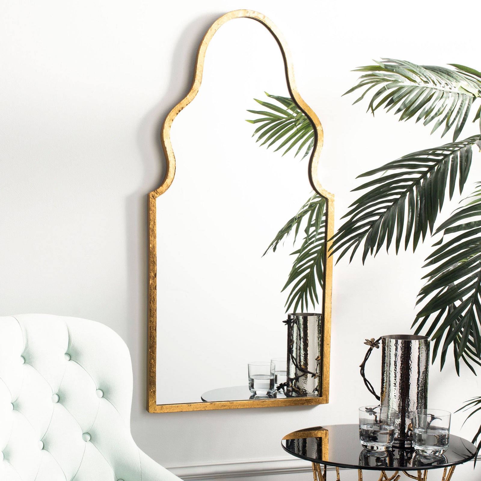 An arched gold mirror adds graceful curves and a warm metallic accent to a bright living space. || MIR4094A || front_room