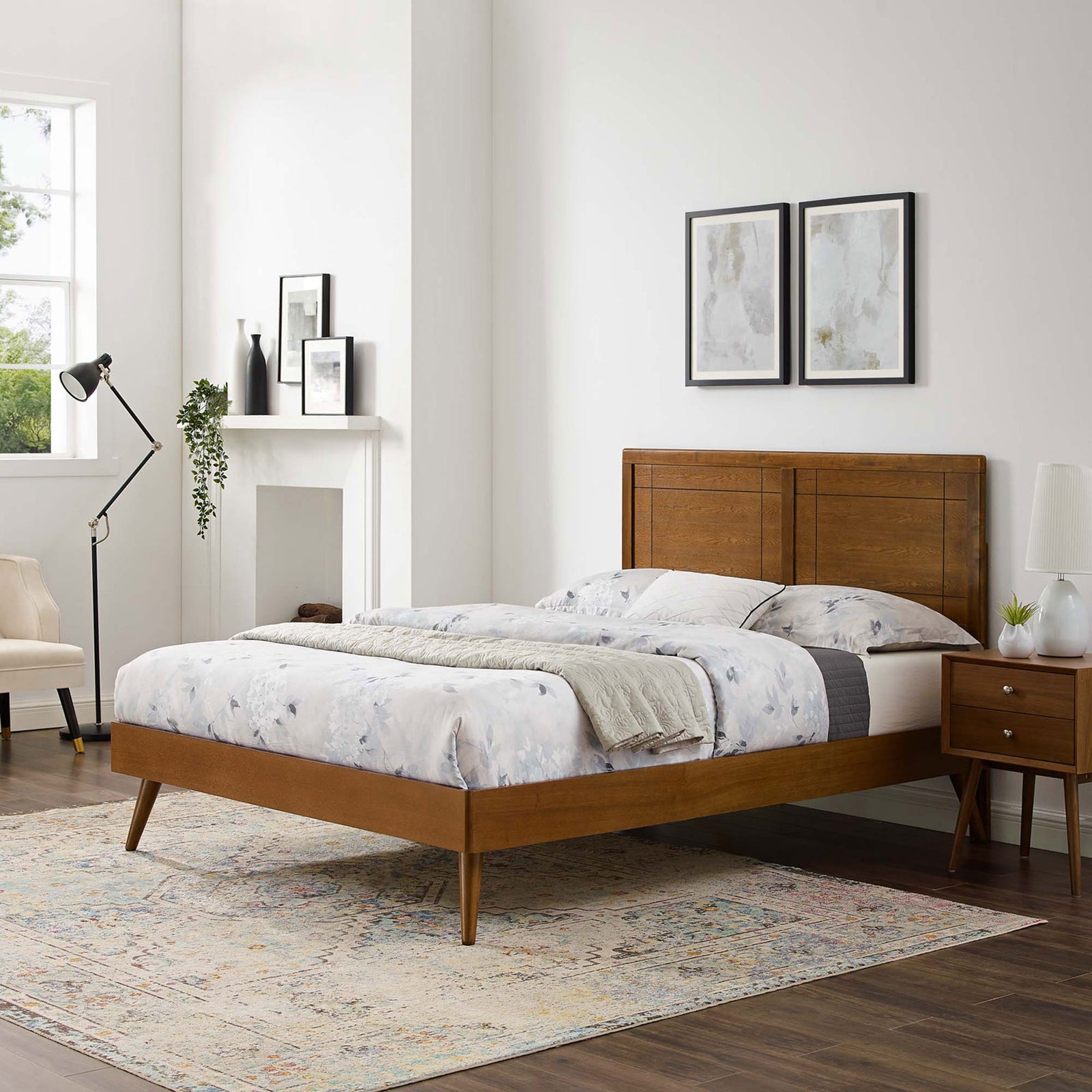 Streamlined platform bed with splayed legs and paneled headboard anchors a modern bedroom || MOD-6382-WAL || front_angle_room
