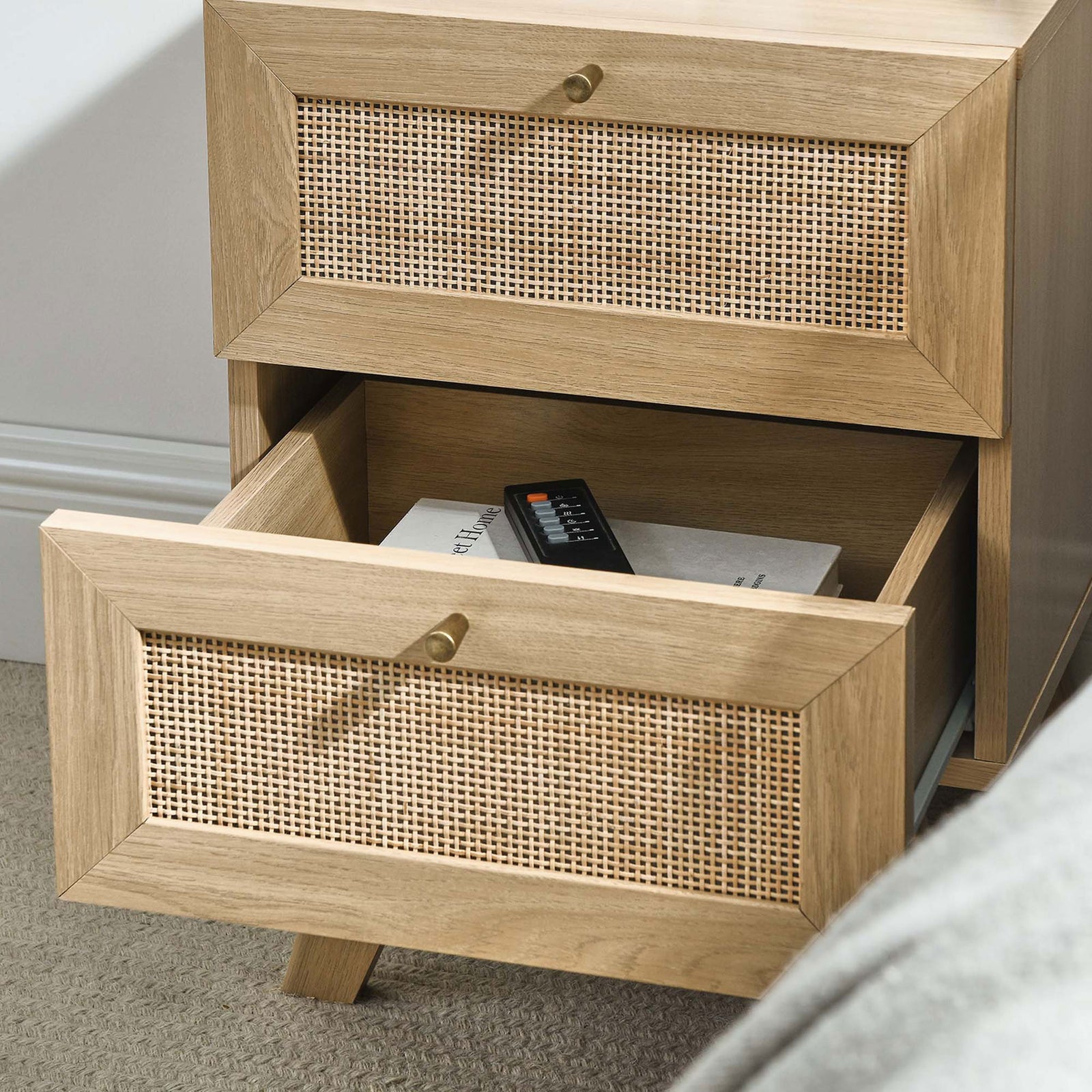 Open drawer keeps remotes and reading materials within reach in this oak and rattan nightstand. || MOD-7050-OAK || storage_open_room