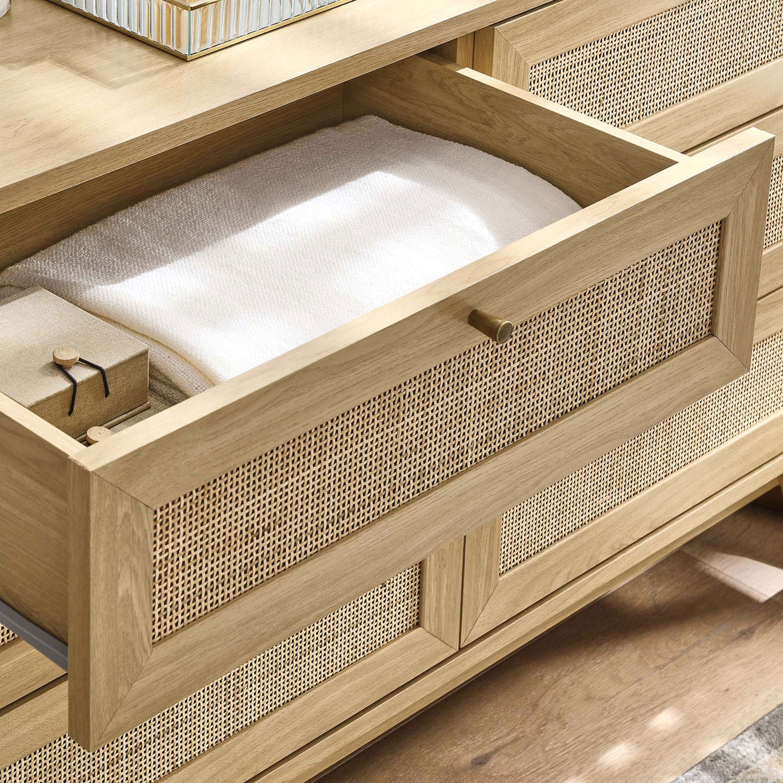 Open Soma dresser drawer styled with linens to show practical bedroom storage and warm oak texture || MOD-7053-OAK || storage_open_room