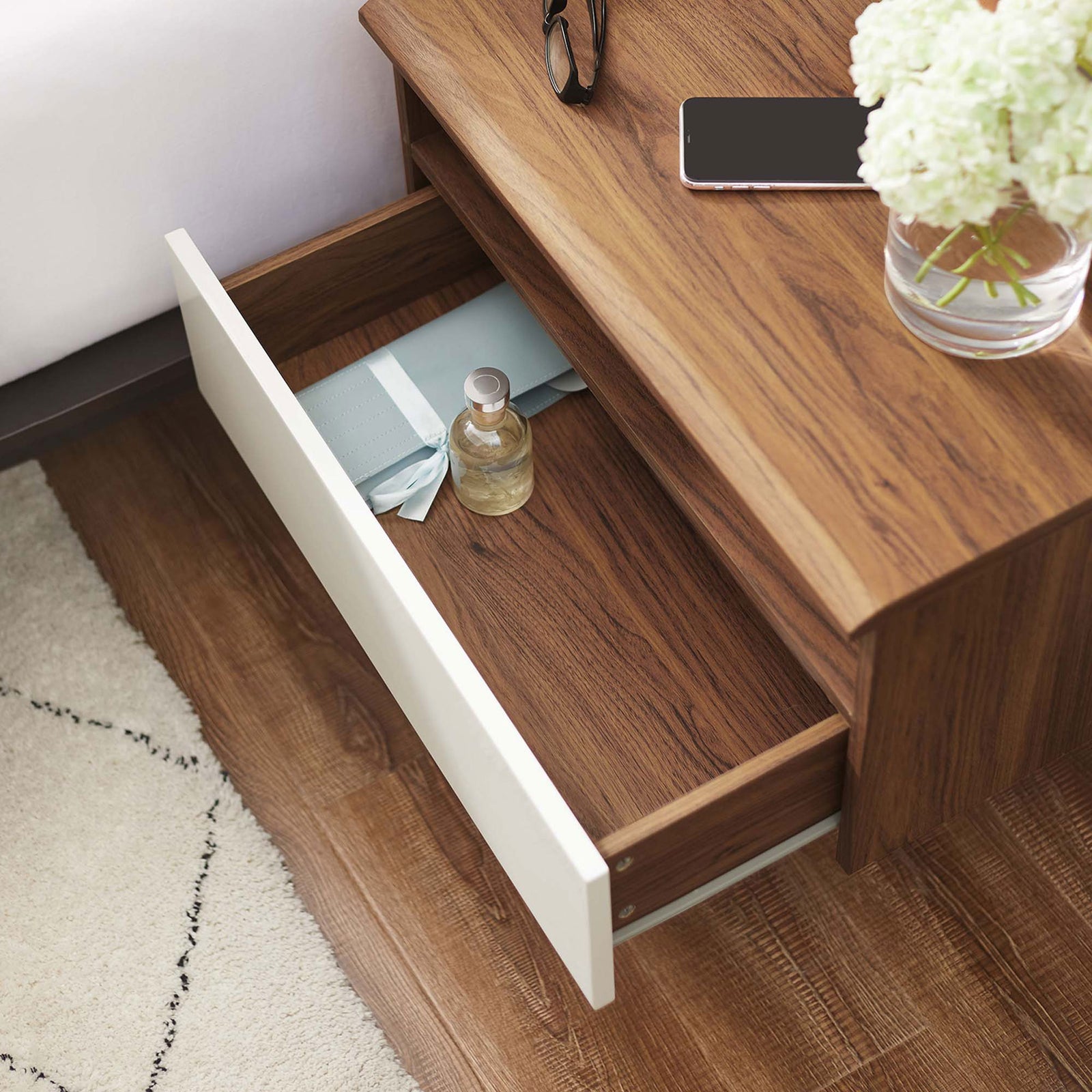 Wall-mounted nightstand styled beside a bed with the drawer open, holding neatly organized bedside essentials. || MOD-7057-WAL-WHI || storage_open_room