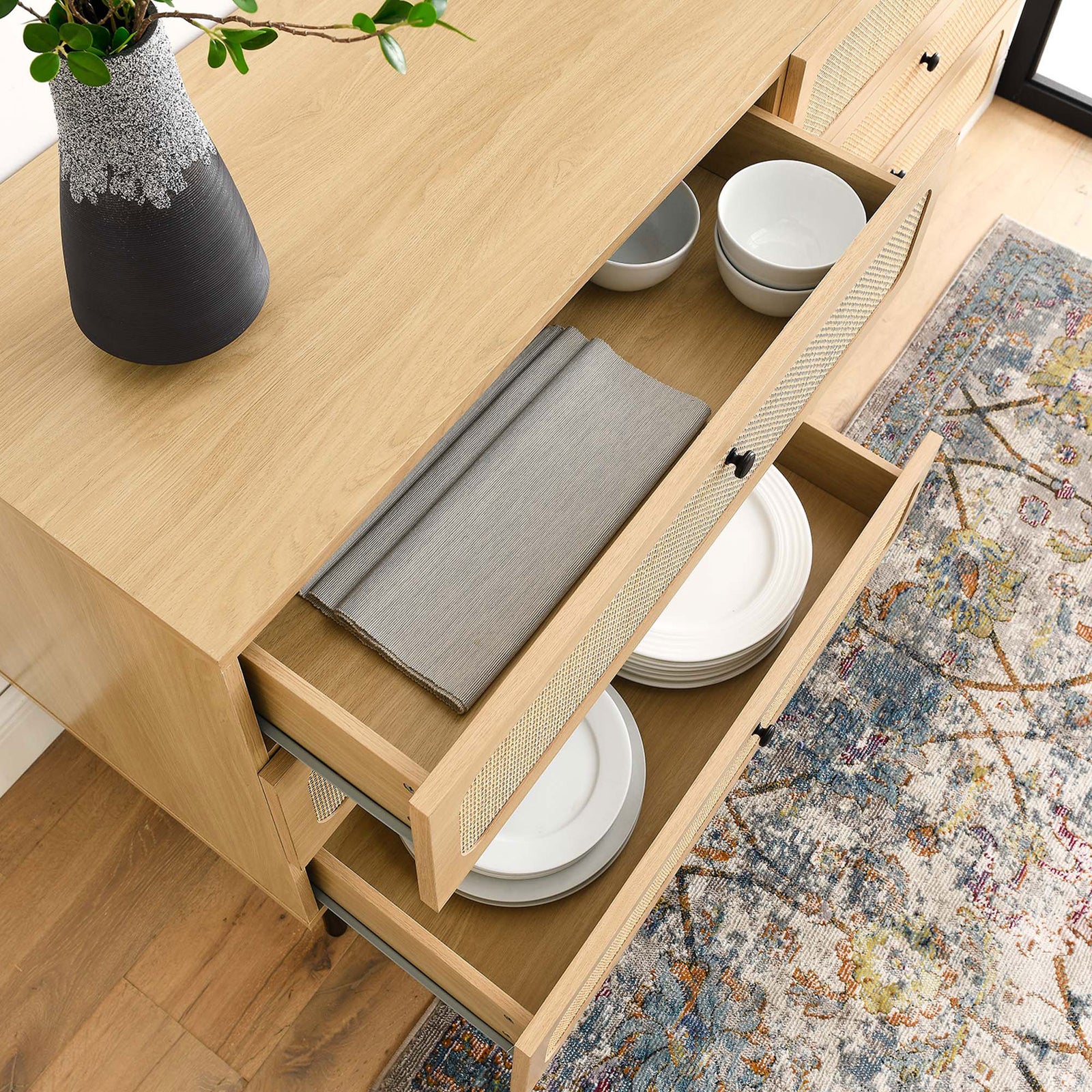 Chaucer dresser drawers neatly organizing plates and linens in a bright modern room || MOD-7067-OAK || storage_open_room