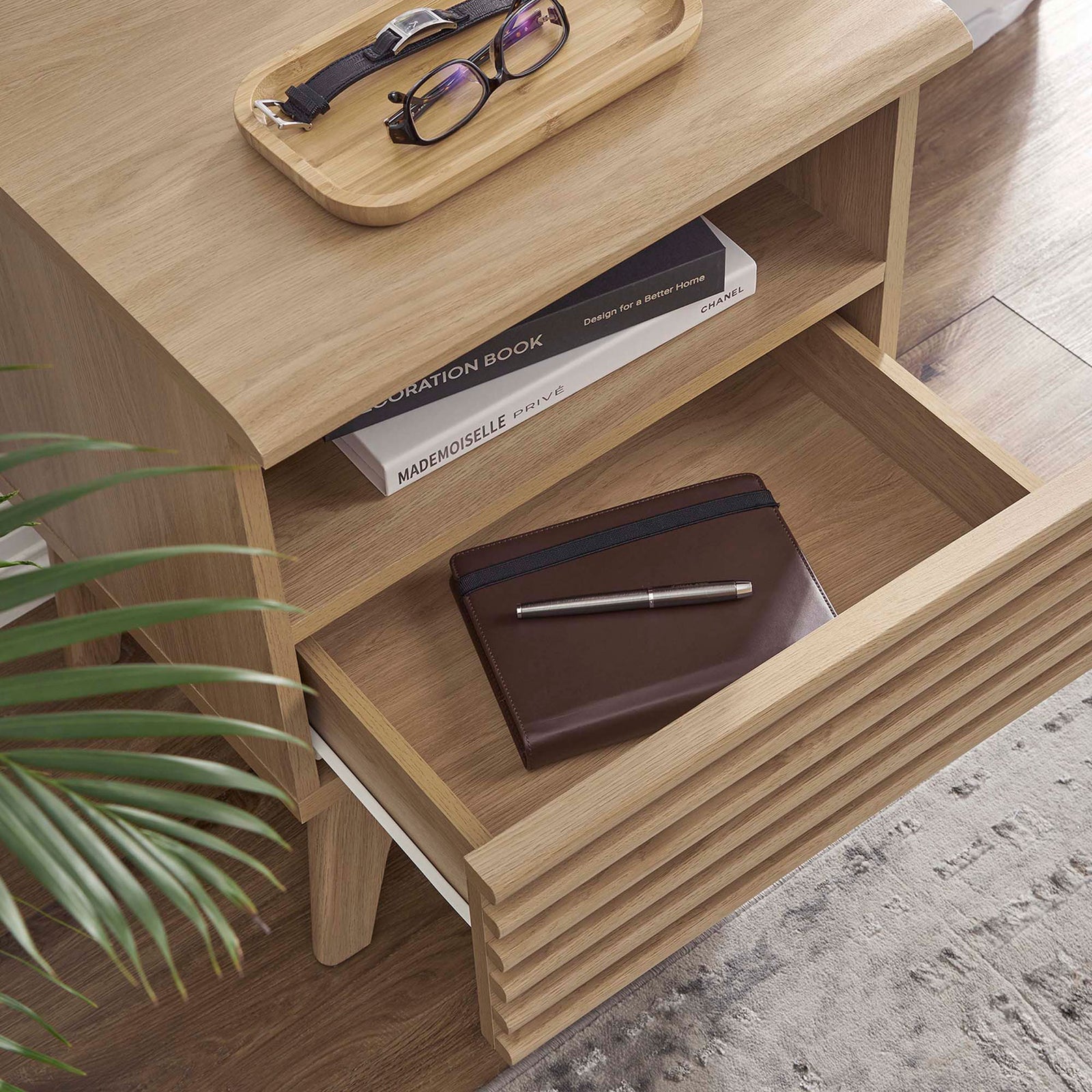 Styled oak nightstand with drawer open, displaying organized bedside essentials in a cozy room setting. || MOD-7070-OAK || storage_open_room