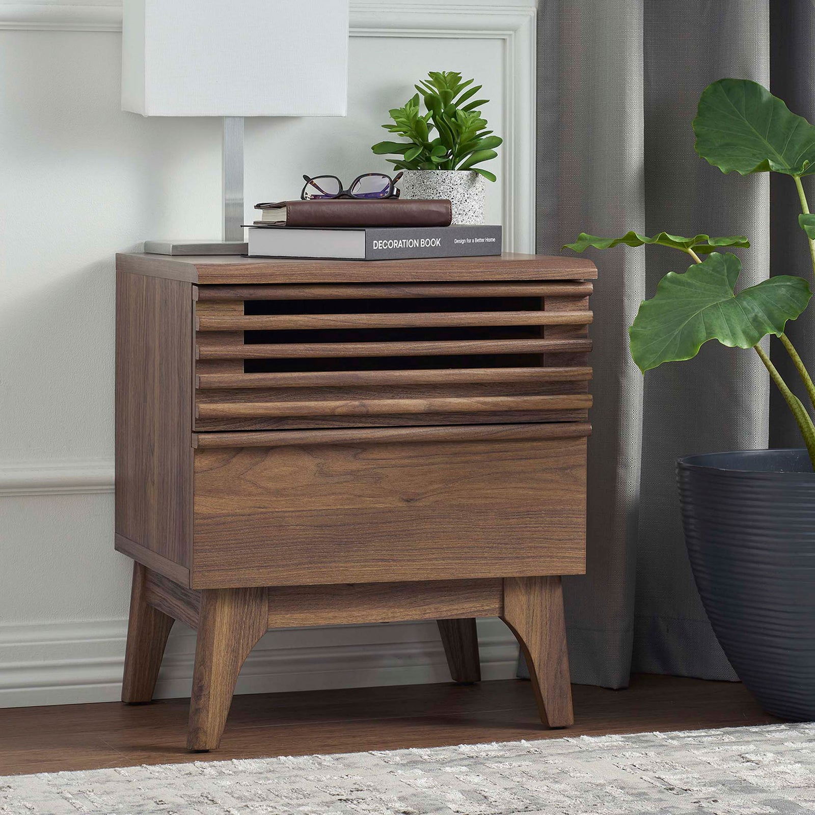 Walnut nightstand styled in a bedroom with books, lamp, and greenery accenting its mid-century design || MOD-7071-WAL || front_angle_room