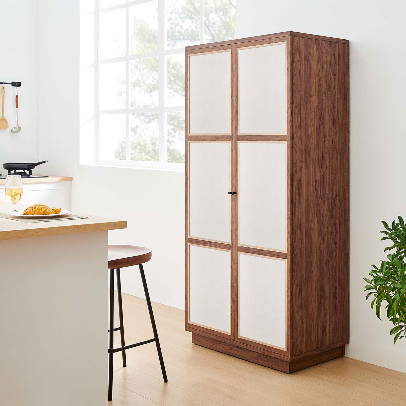 Walnut Capri cabinet placed beside a kitchen island, providing pantry-style closed storage || MOD-7156-WAL || front_angle_room