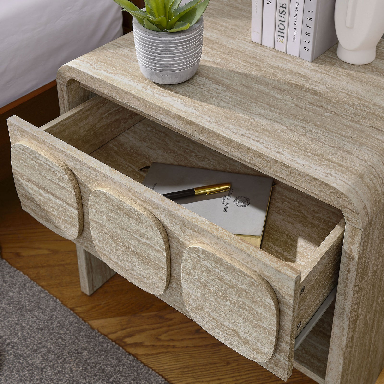 Nightstand in use beside the bed, with drawer open to store journals and accessories within easy reach. || MOD-7160-TRA || storage_open_room