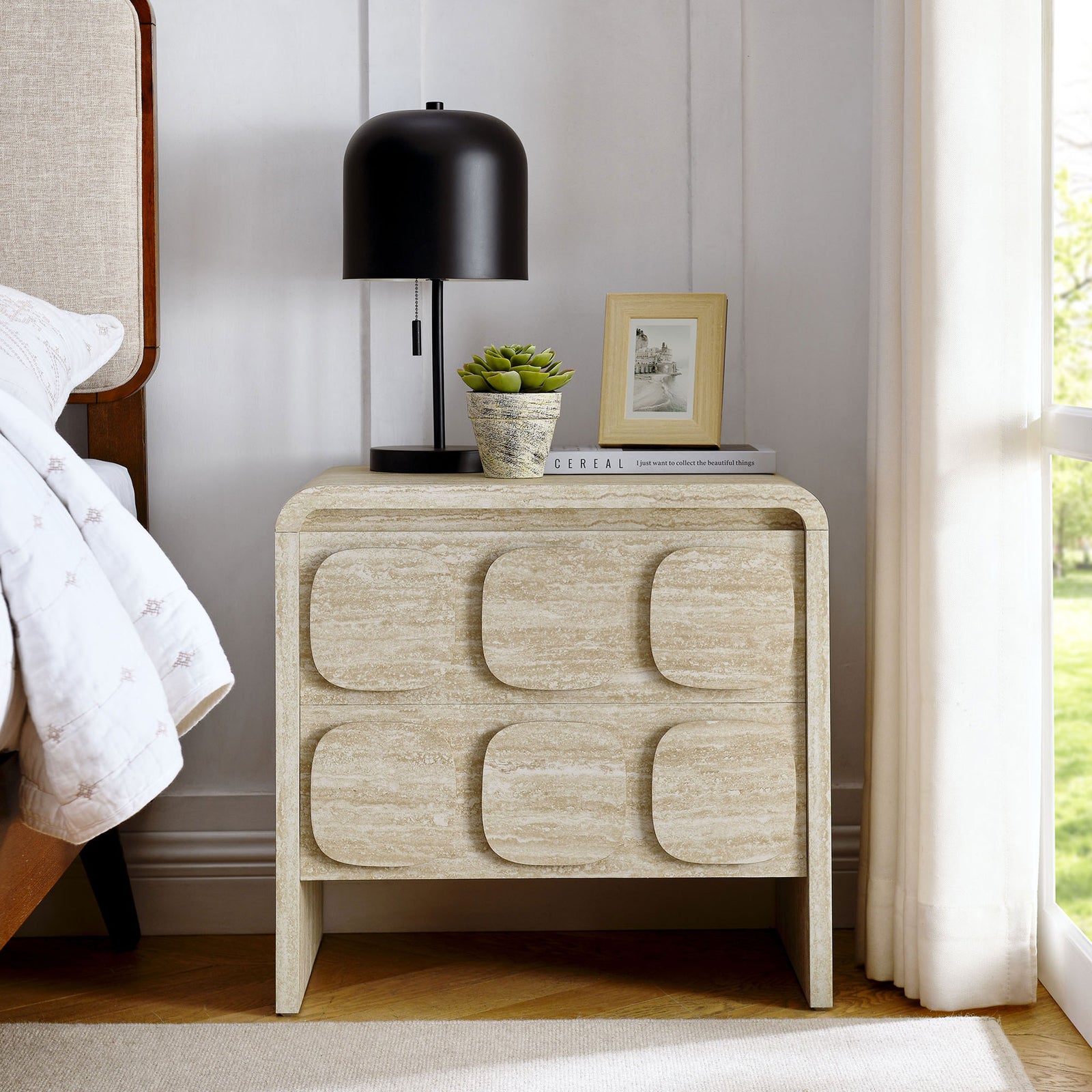 Toscana travertine-look nightstand styled beside a bed with lamp and decor in a bright modern bedroom || MOD-7161-TRA || front_room