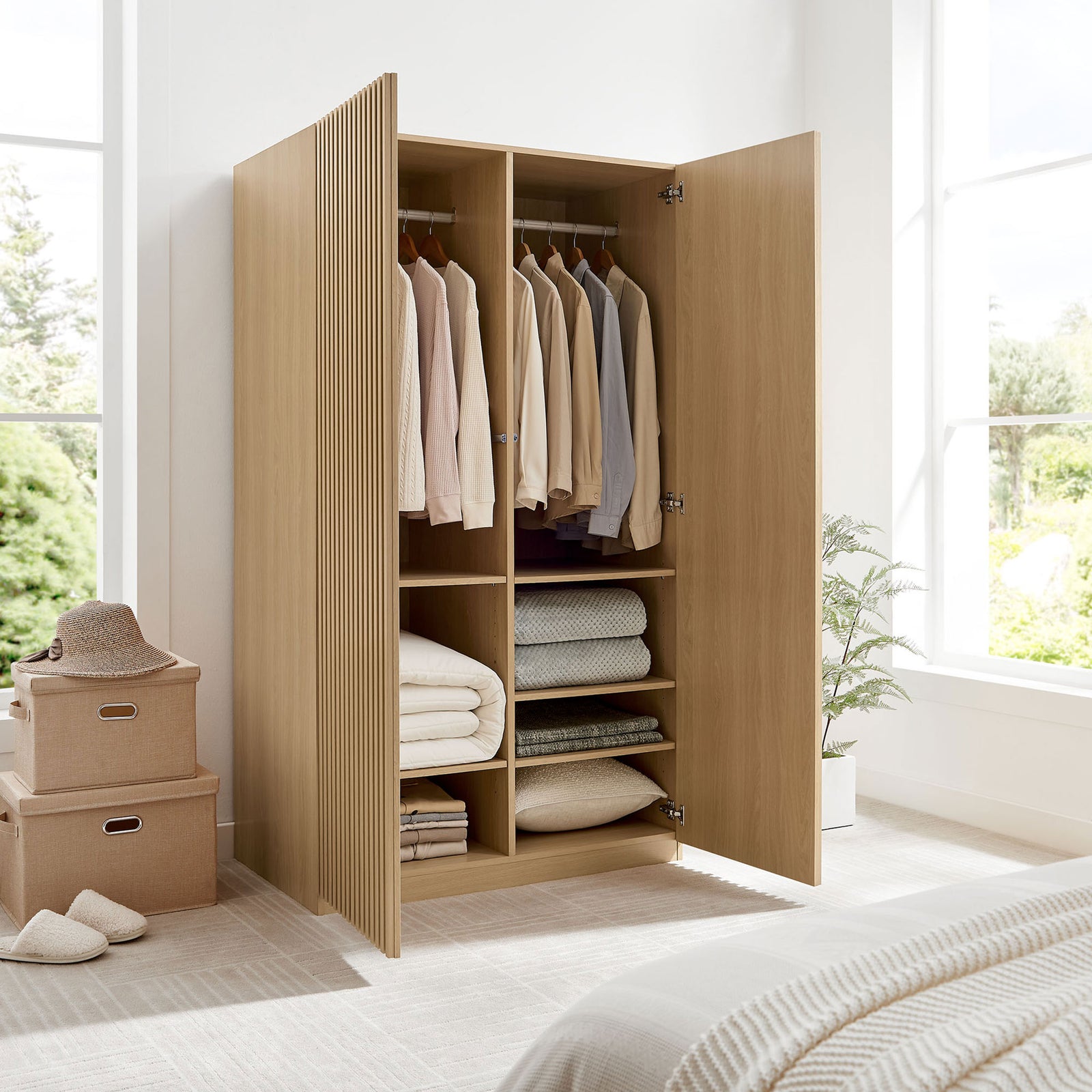 Oak wardrobe in a bright bedroom fully opened to show hanging space and neatly organized shelves || MOD-7182-OAK || front_angle_open_room