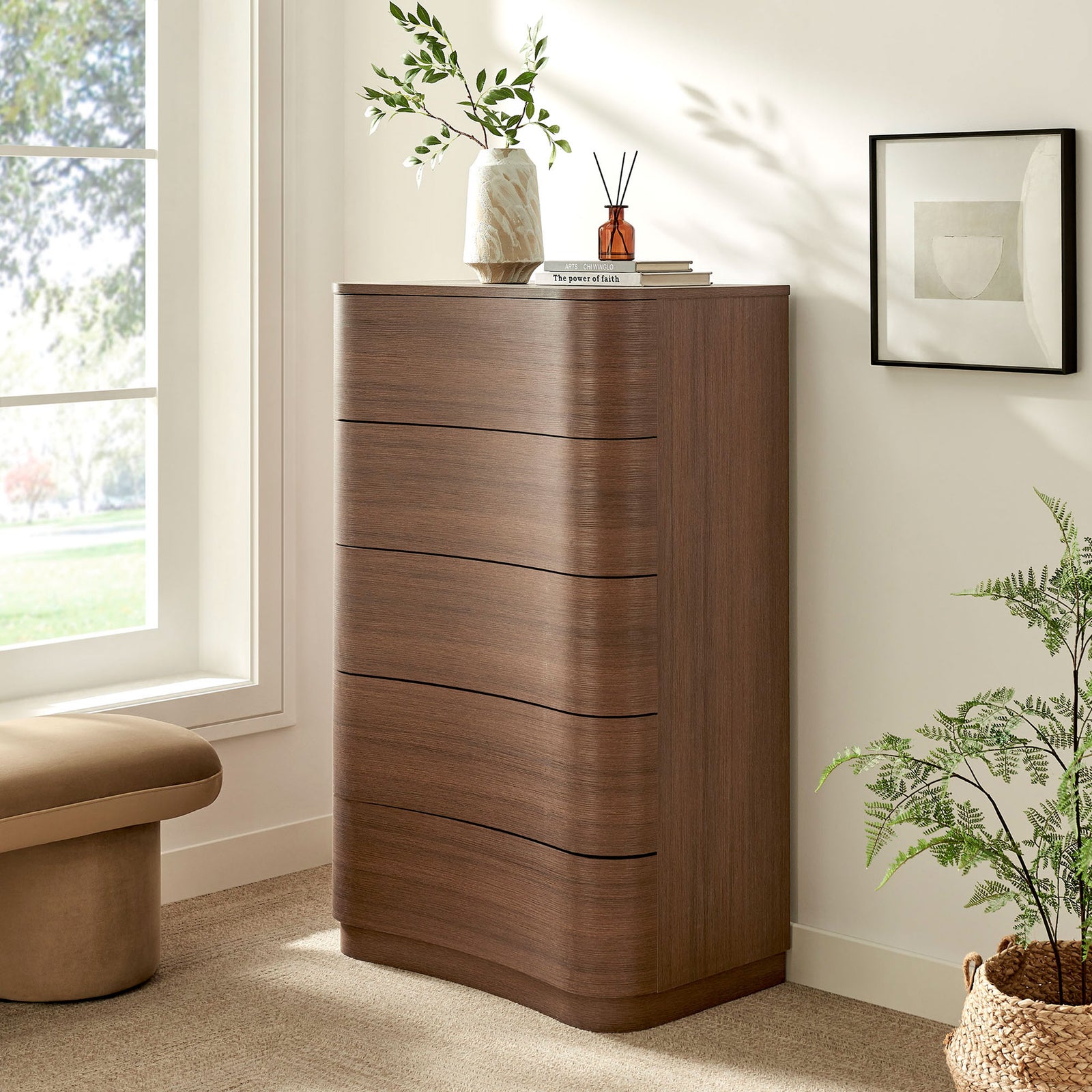 Mirae curved dresser chest styled in a bright bedroom with greenery, artwork, and soft neutral decor accents. || MOD-7231-BBO || front_angle_room