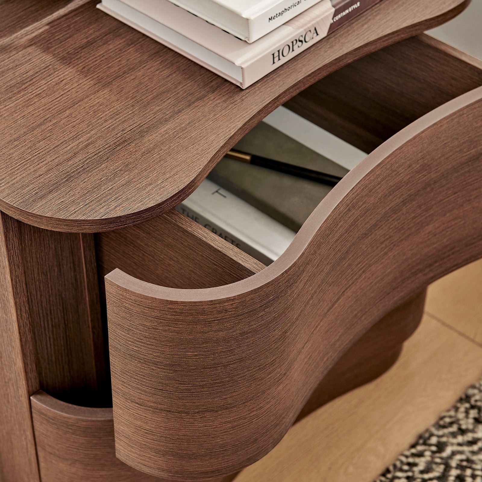 Top drawer of the Mirae nightstand keeps books and accessories within easy reach in a warm, modern bedroom || MOD-7232-BBO || storage_open_room