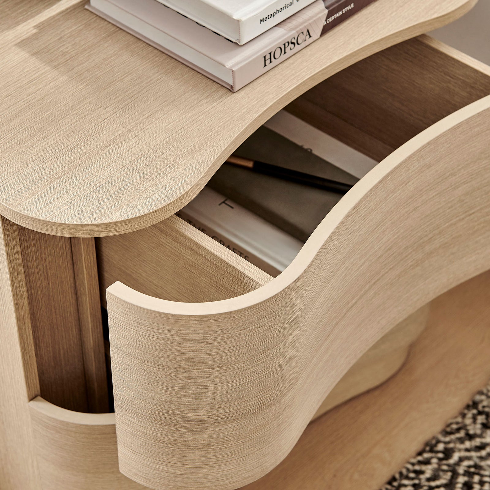 Styled nightstand drawer keeps books and essentials organized, highlighting the sculpted curved front design || MOD-7232-BOA || storage_open_room