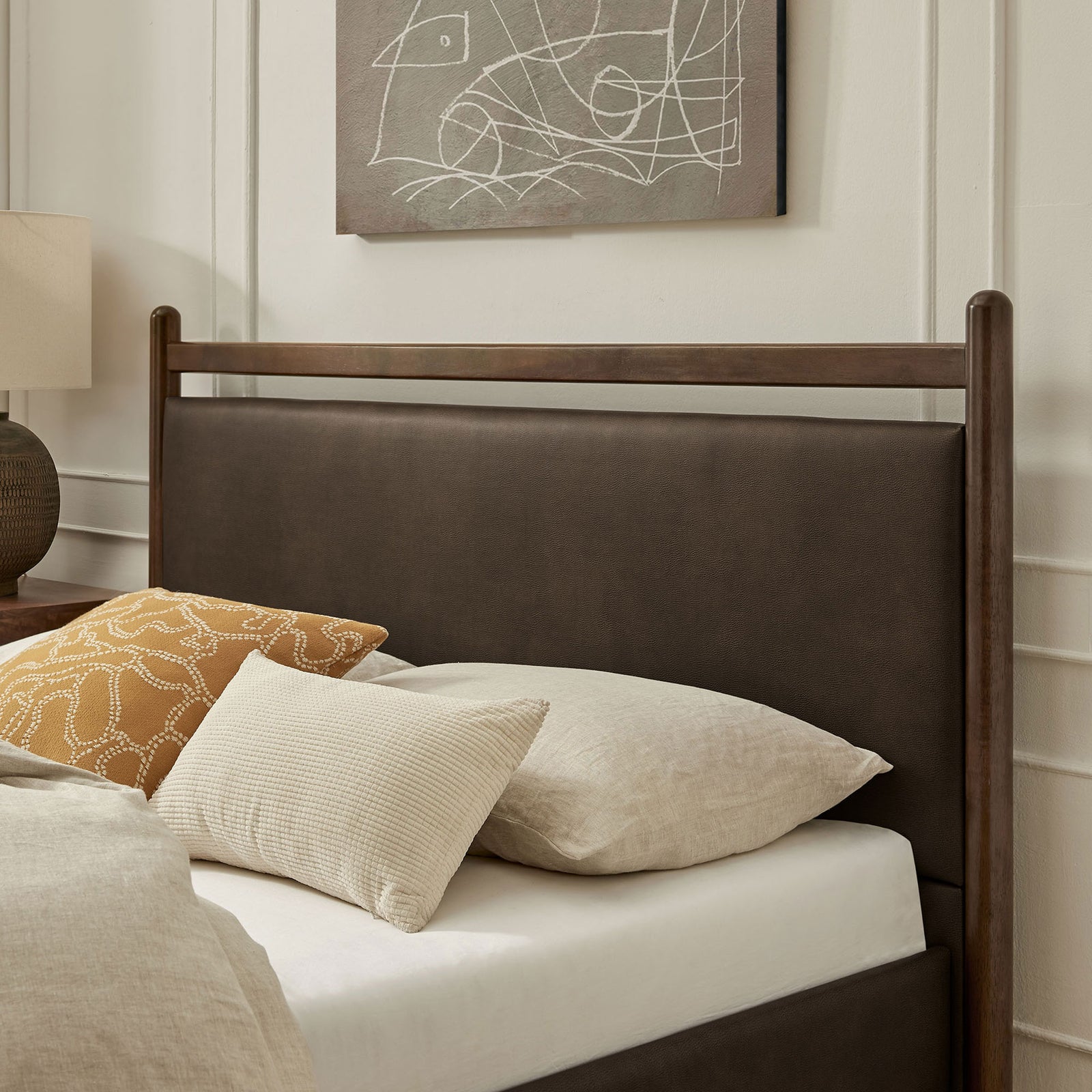 Cushioned headboard in mushroom vegan leather pairs with warm wood for inviting bedroom comfort || MOD-7249-WEN-MUS || detail_room