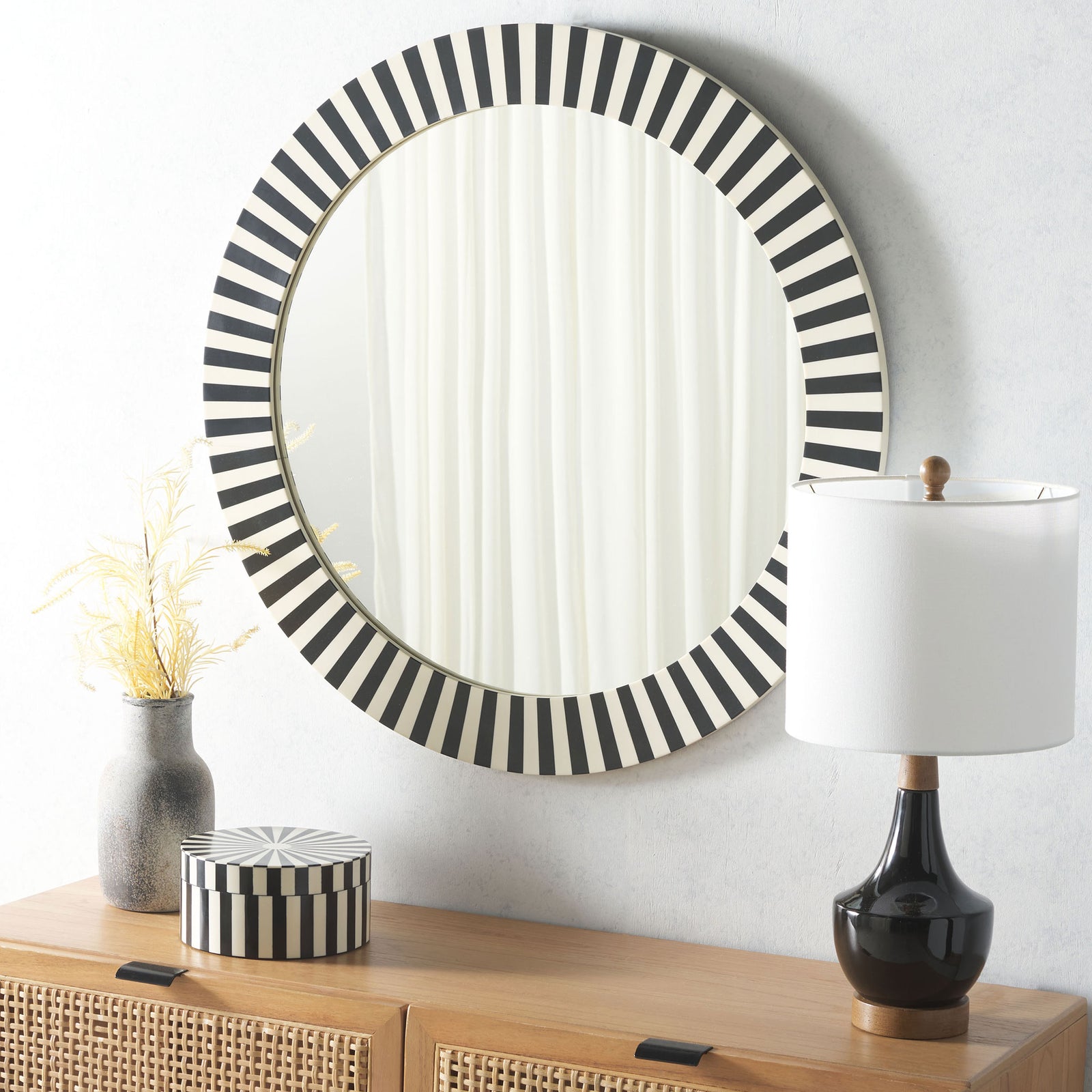 A graphic round mirror adds black-and-ivory contrast above a wood console || MRR1500A || front_room