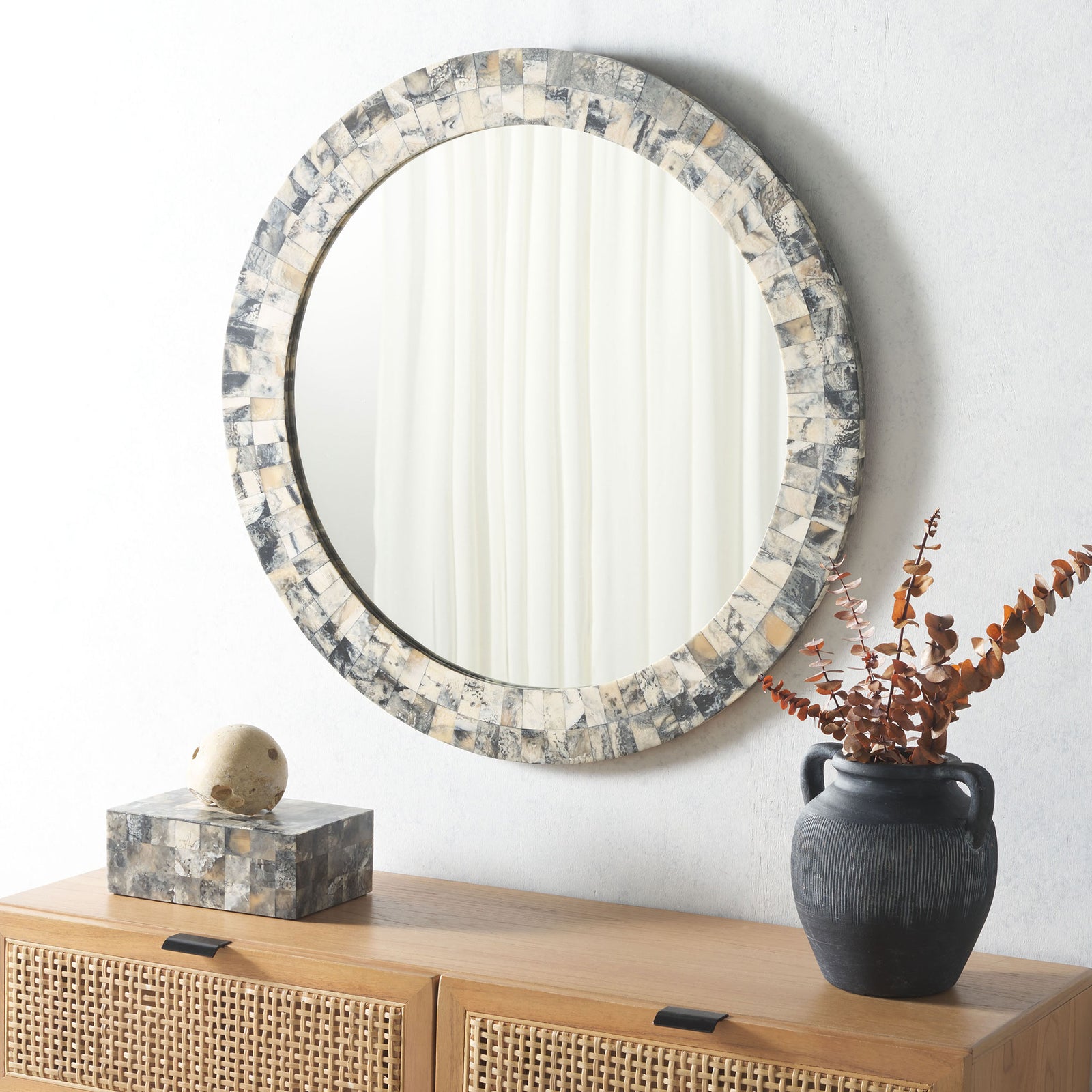 A round mosaic mirror adds warm ivory, smoky gray, and amber character above a wood console. || MRR1503A || front_angle_room